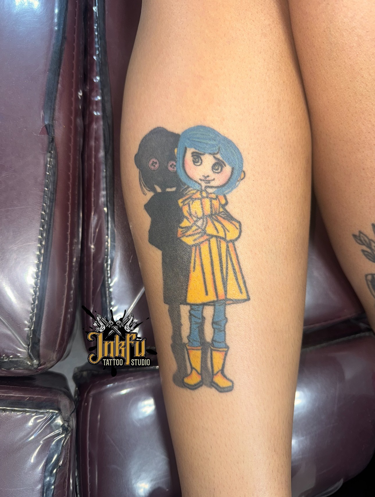 Color illustrative tattoo of the Coraline character on the calf, by Meer Rich