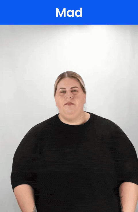 Animated GIF: a Deaf signer signs MAD in ASL, a claw hand held in front of the face with a frown.