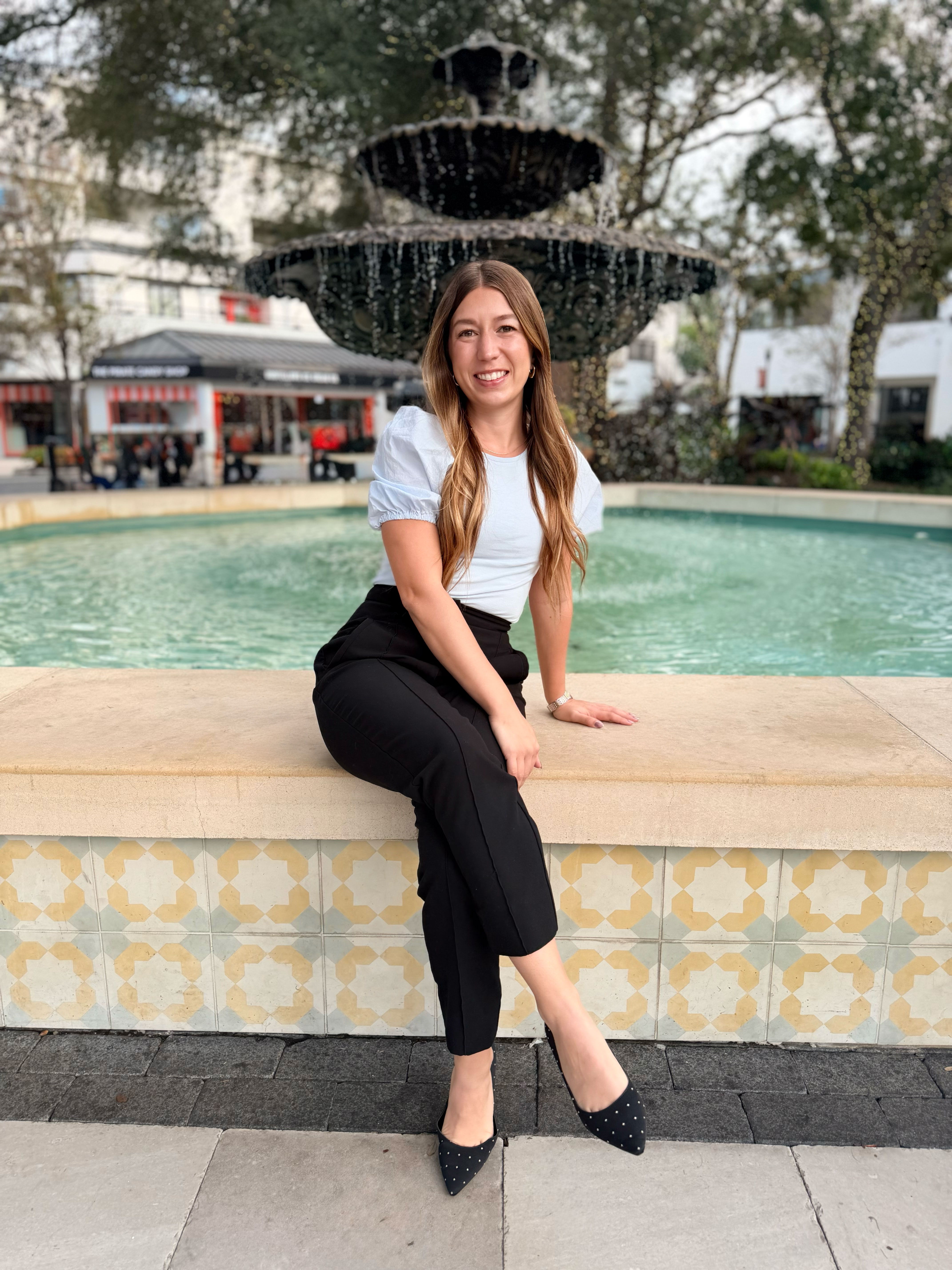 Julie Morris sitting by a fountain in Hyde Park, Tampa Bay