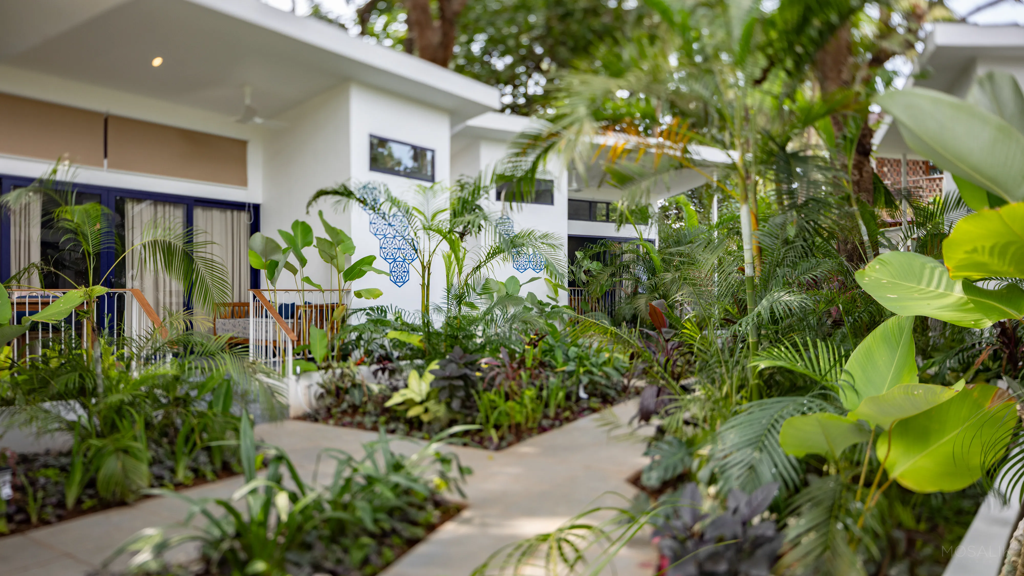 Tropical courtyard path between the garden rooms at Jaali Blue, Patnem