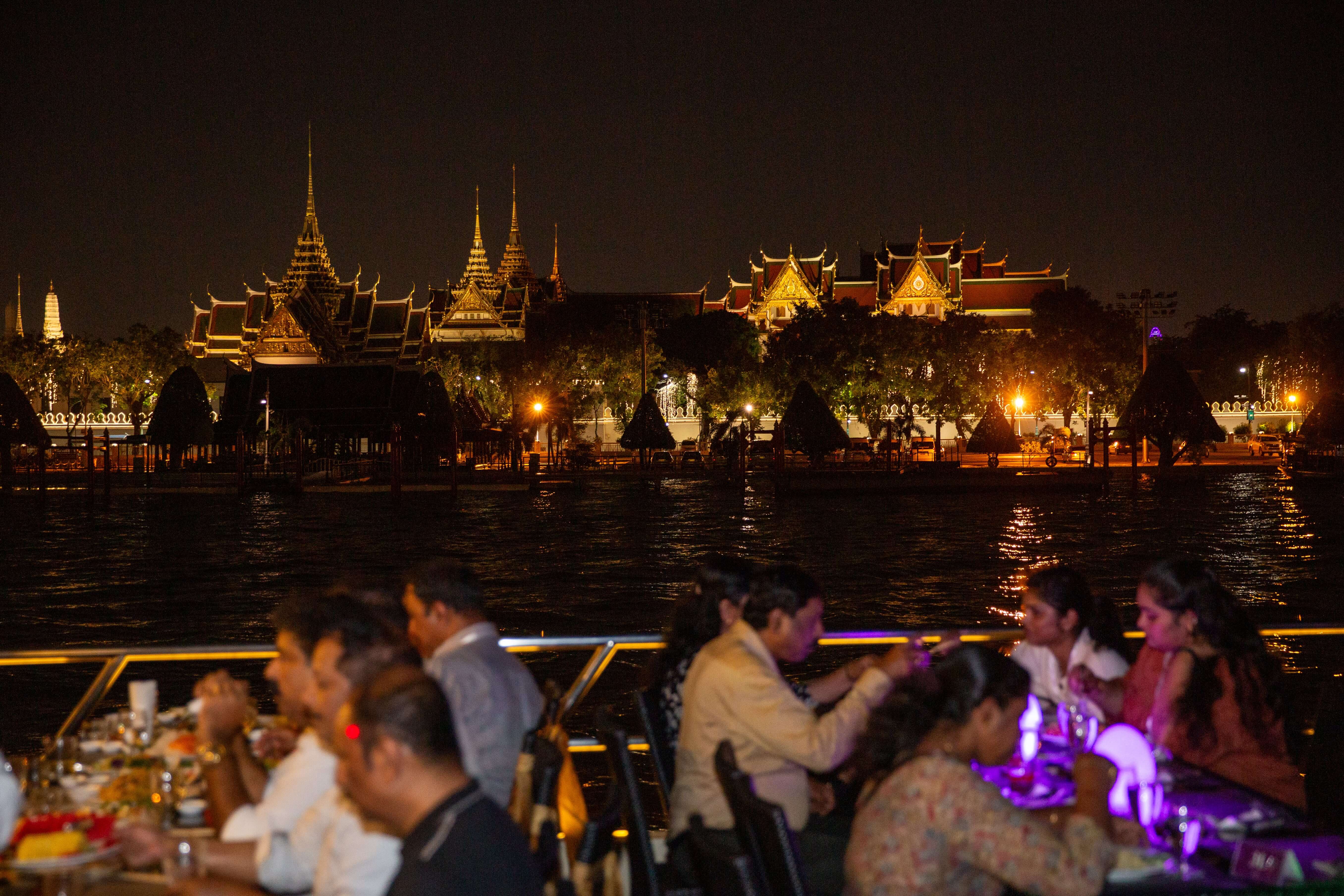 Person in dark cloak stands in glowing orange sandstone canyon