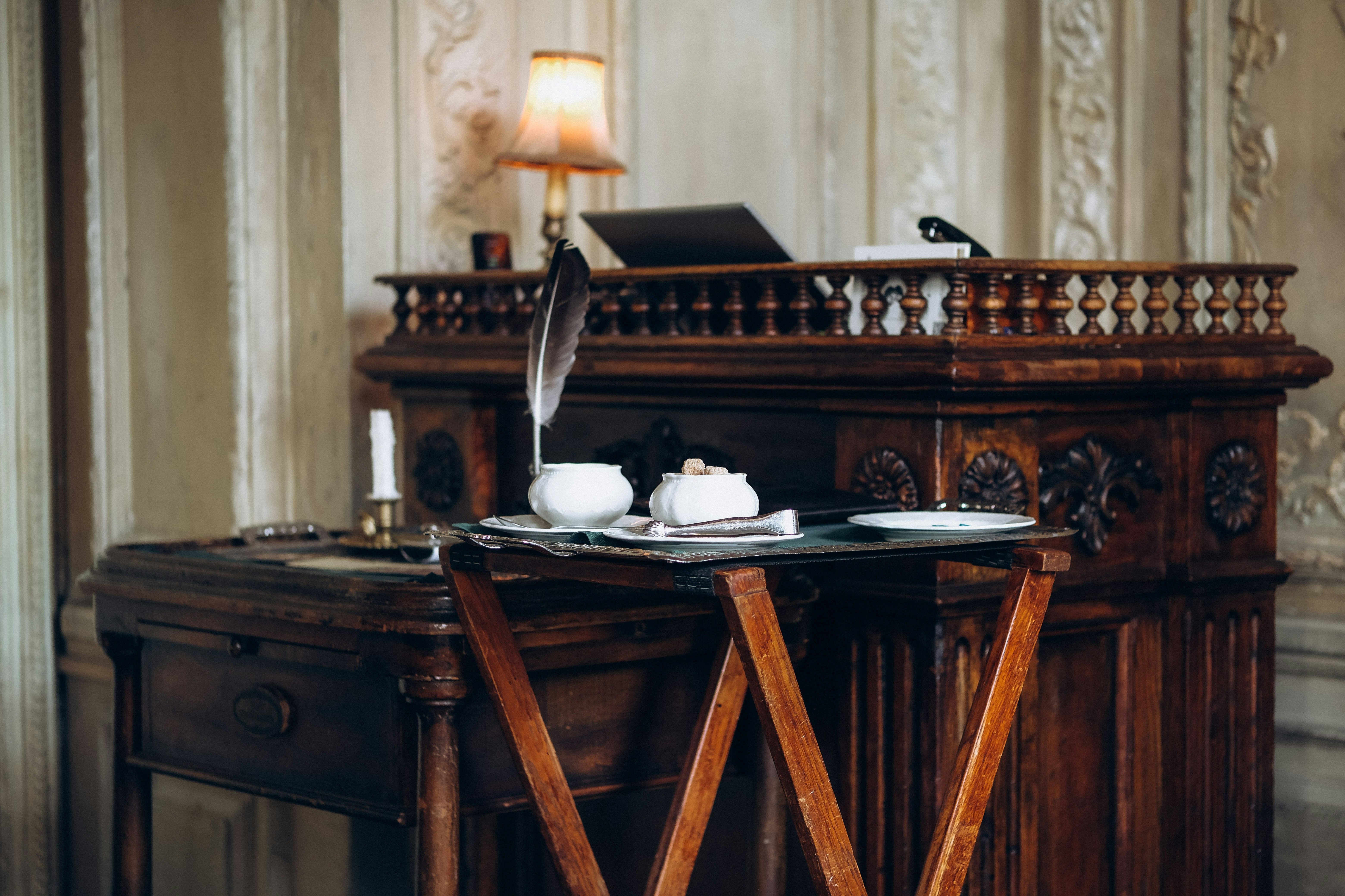 An antique desk with a feather quill.