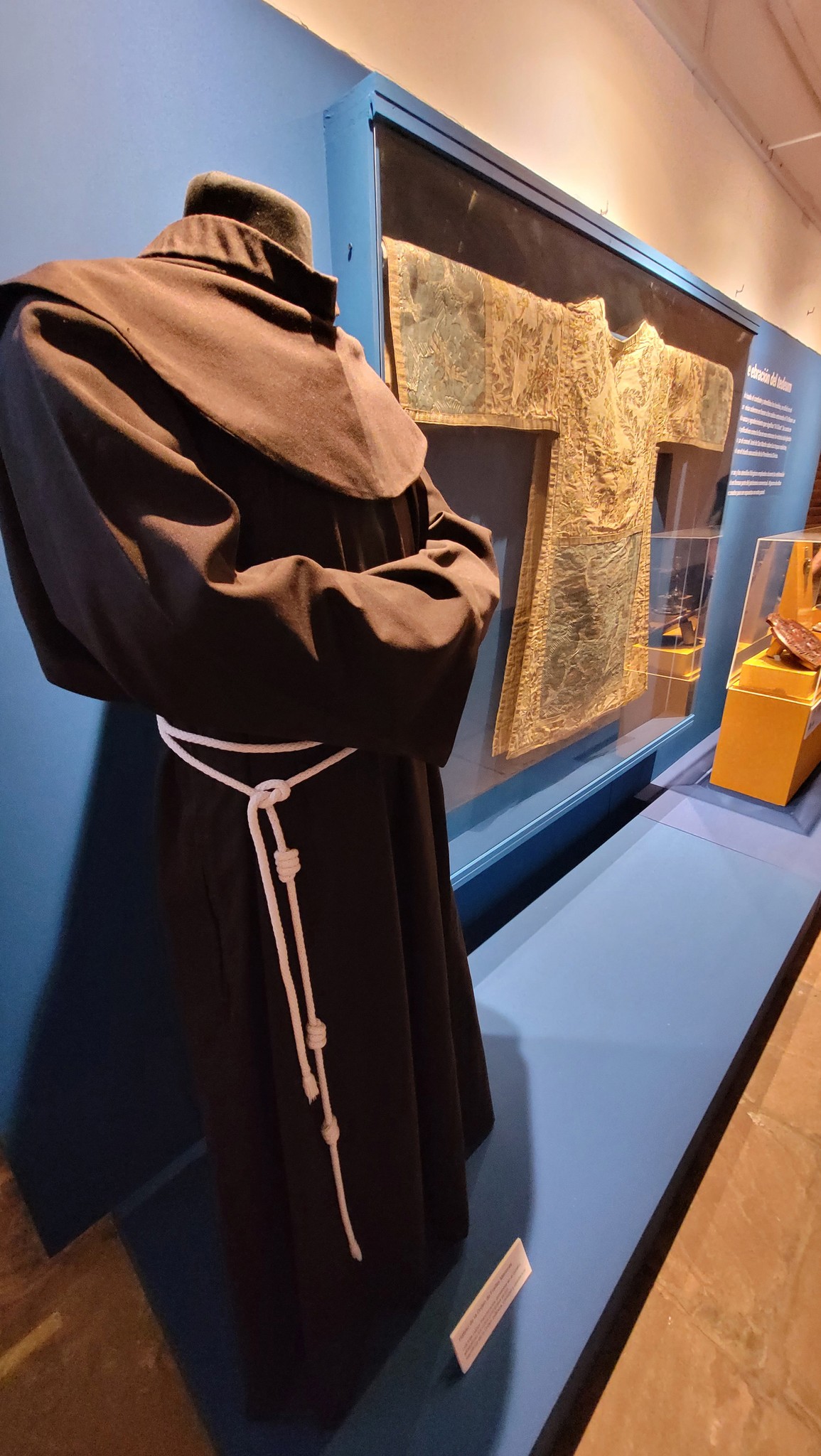 Black and white photo of two people looking at a computer screen with papers on wall