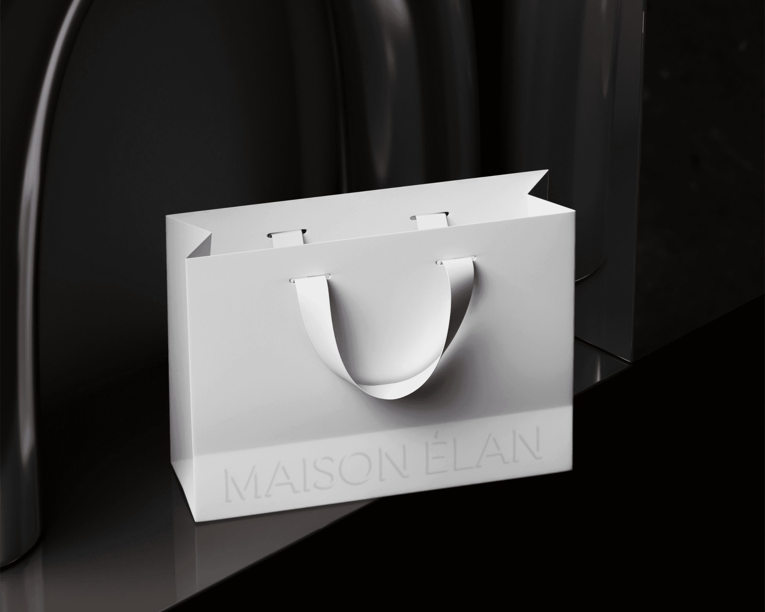 A Maison Élan shopping bag. The bag is plain white with the brand logo embossed on the bottom.