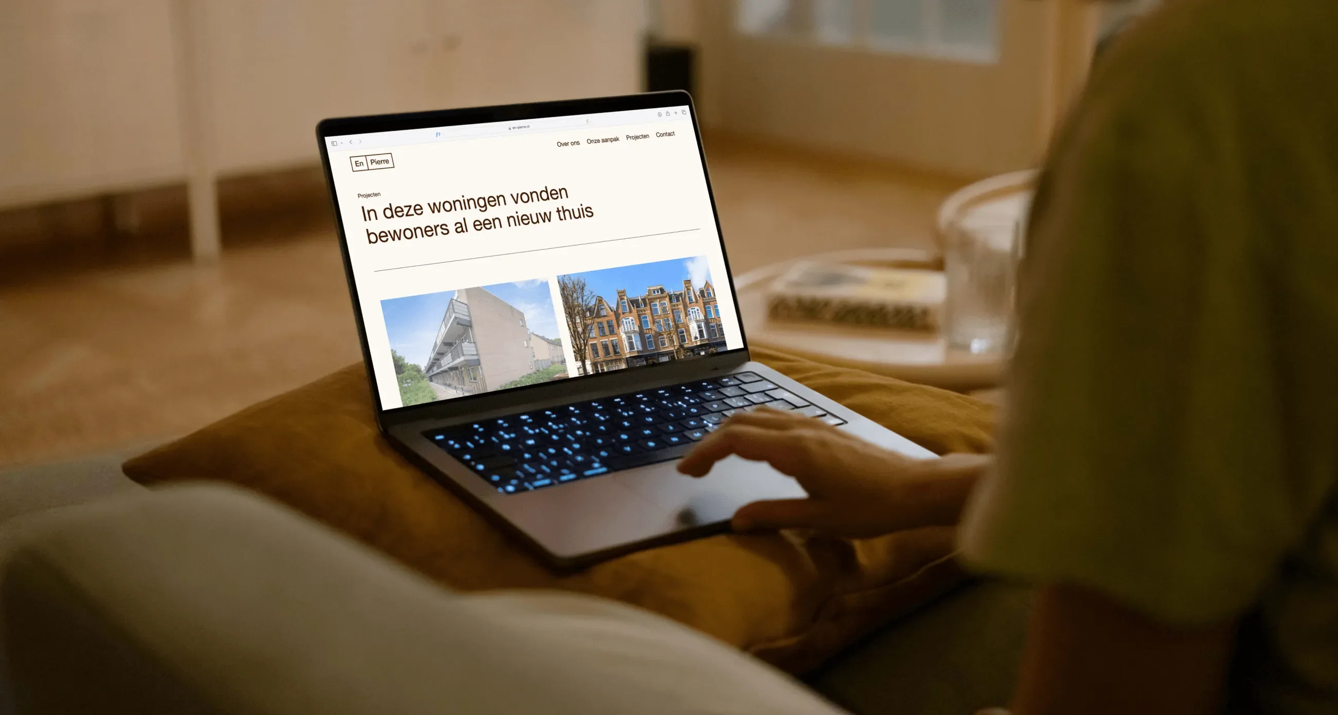 Person sitting on a couch using a laptop