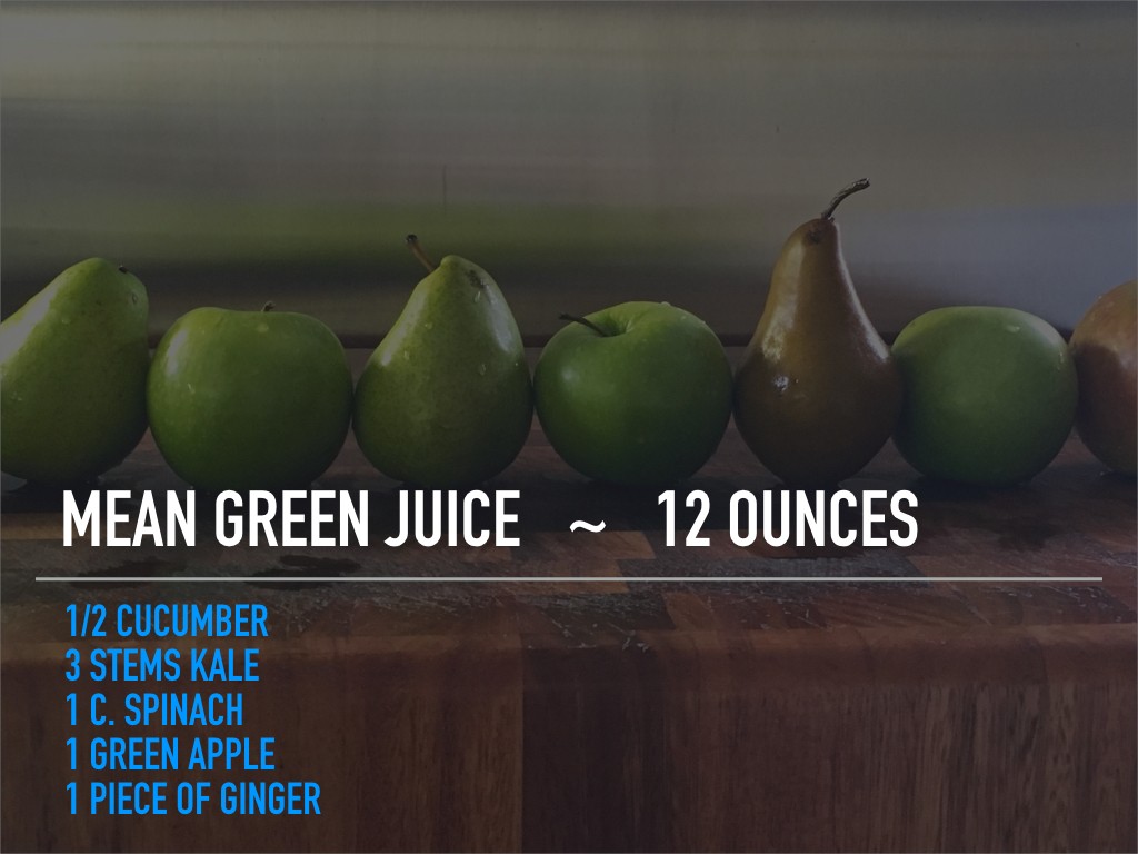 Seven green pears are lined up on a wooden surface in front of a stainless steel background, with text overlaying that reads "Mean Green Juice ~ 12 Ounces" along with ingredients listed below, including cucumber, kale, spinach, green apple, and ginger.