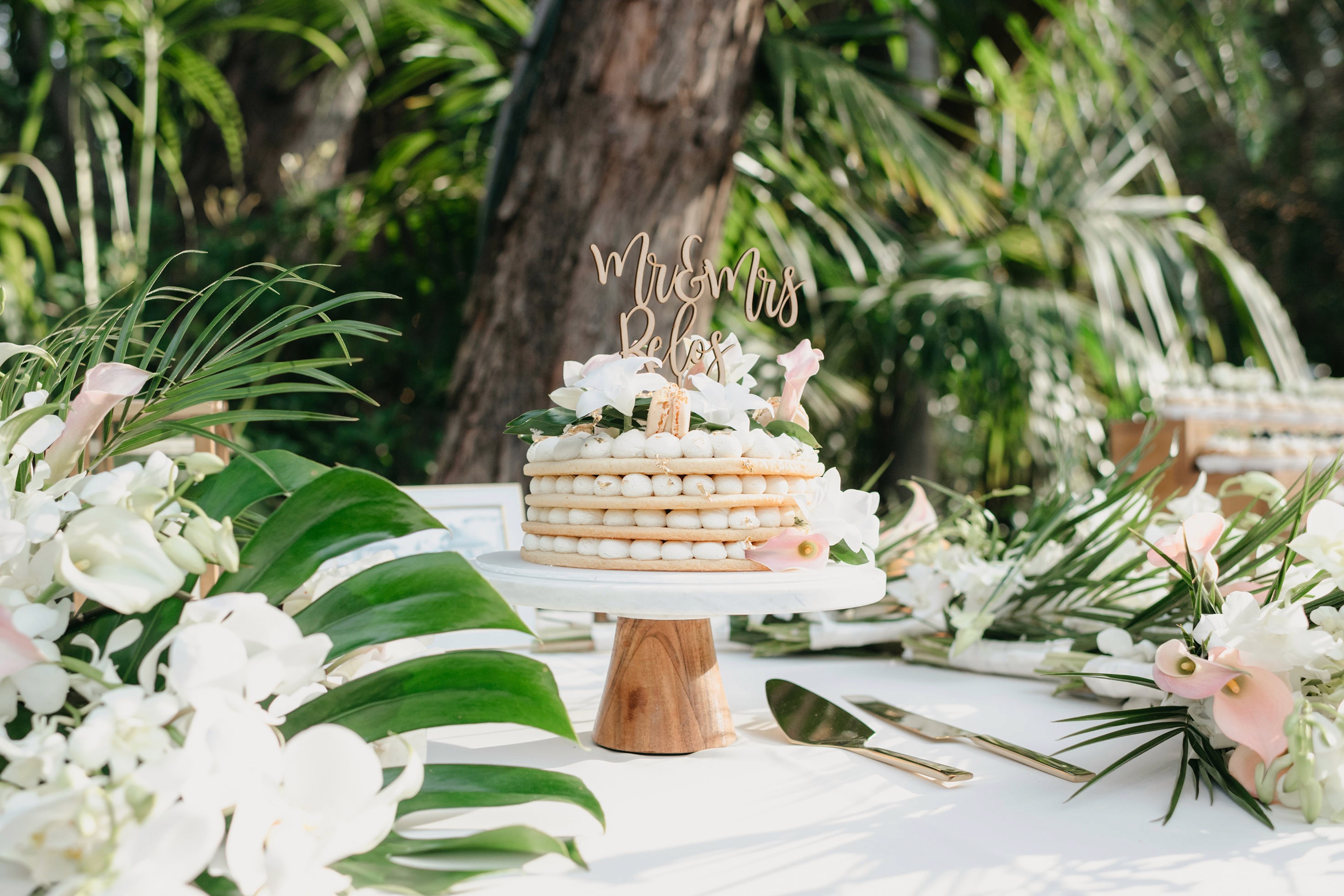 Flat lay wedding details with bouquet, rings, and sparkling bridal heels