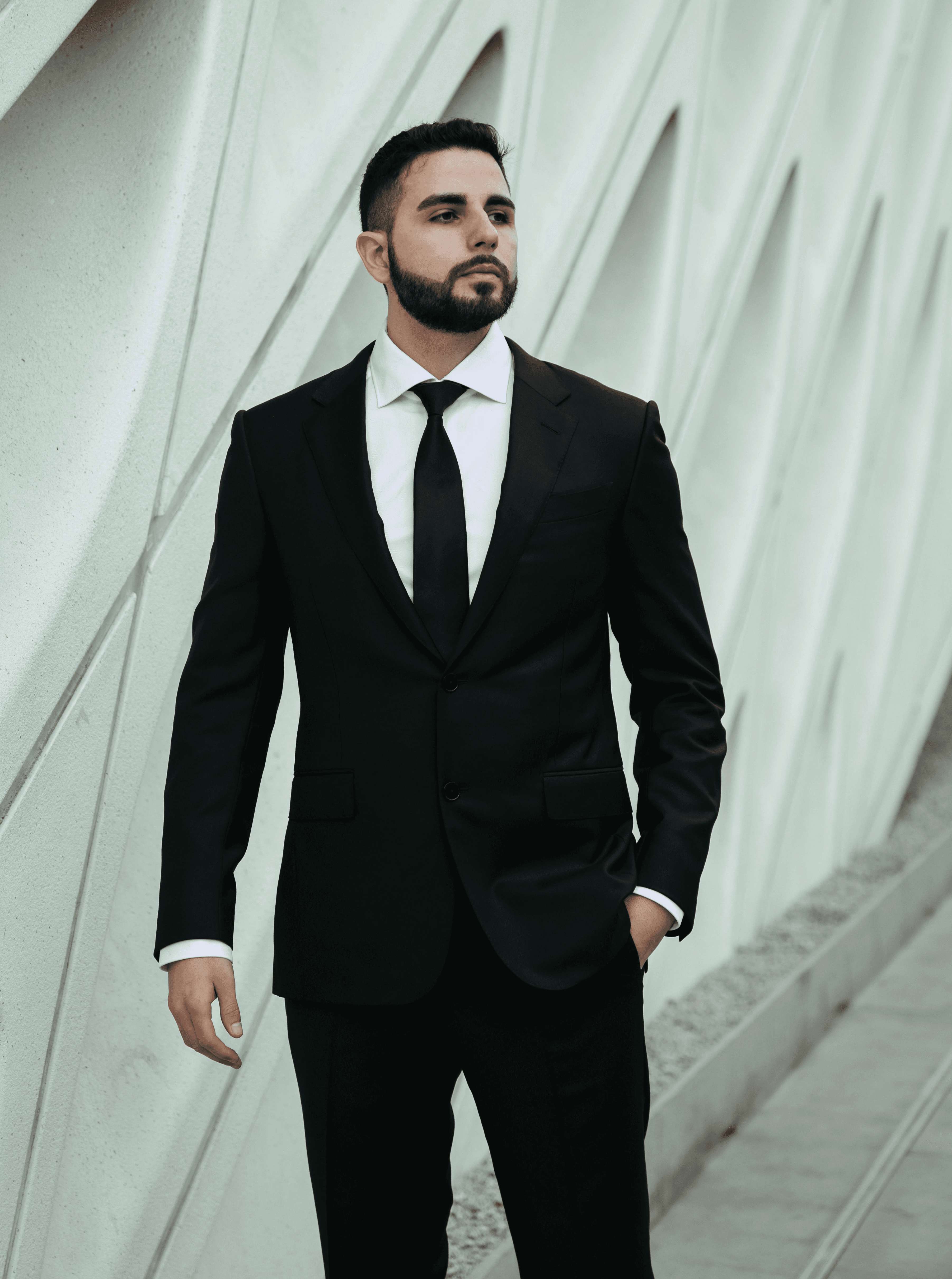 Jon Sargsyan, a founder and partner of The Injury Law Firm, looking off into the distance wearing a black suit