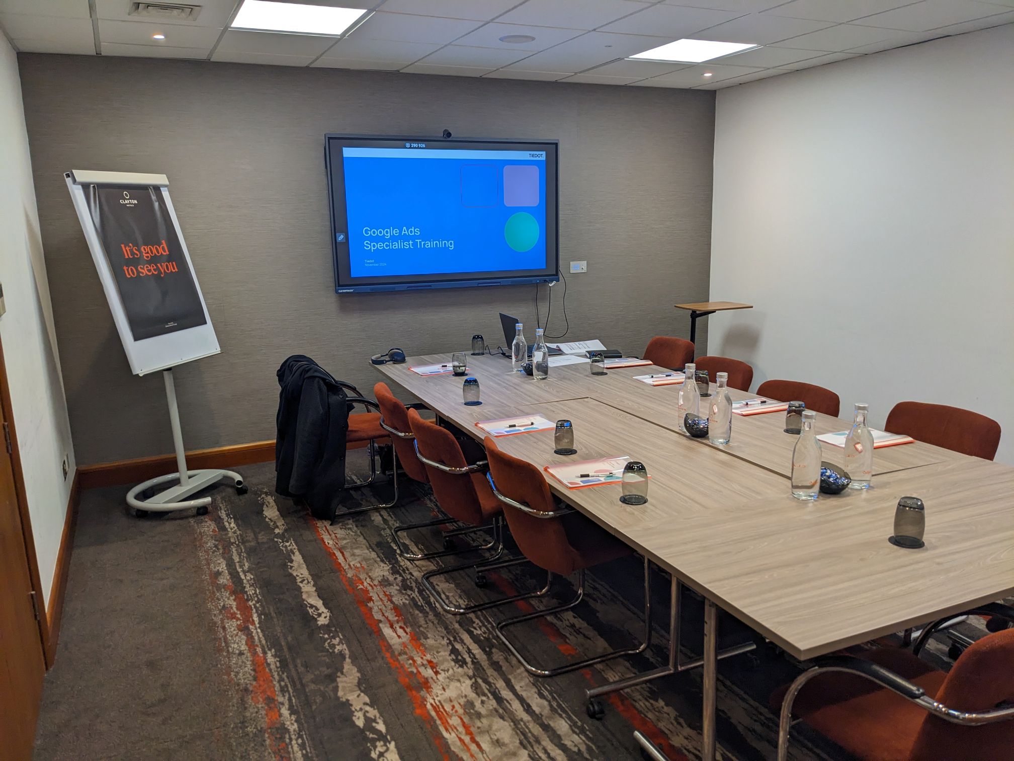 The Tiedot team collaborating around a table with laptops during a meeting