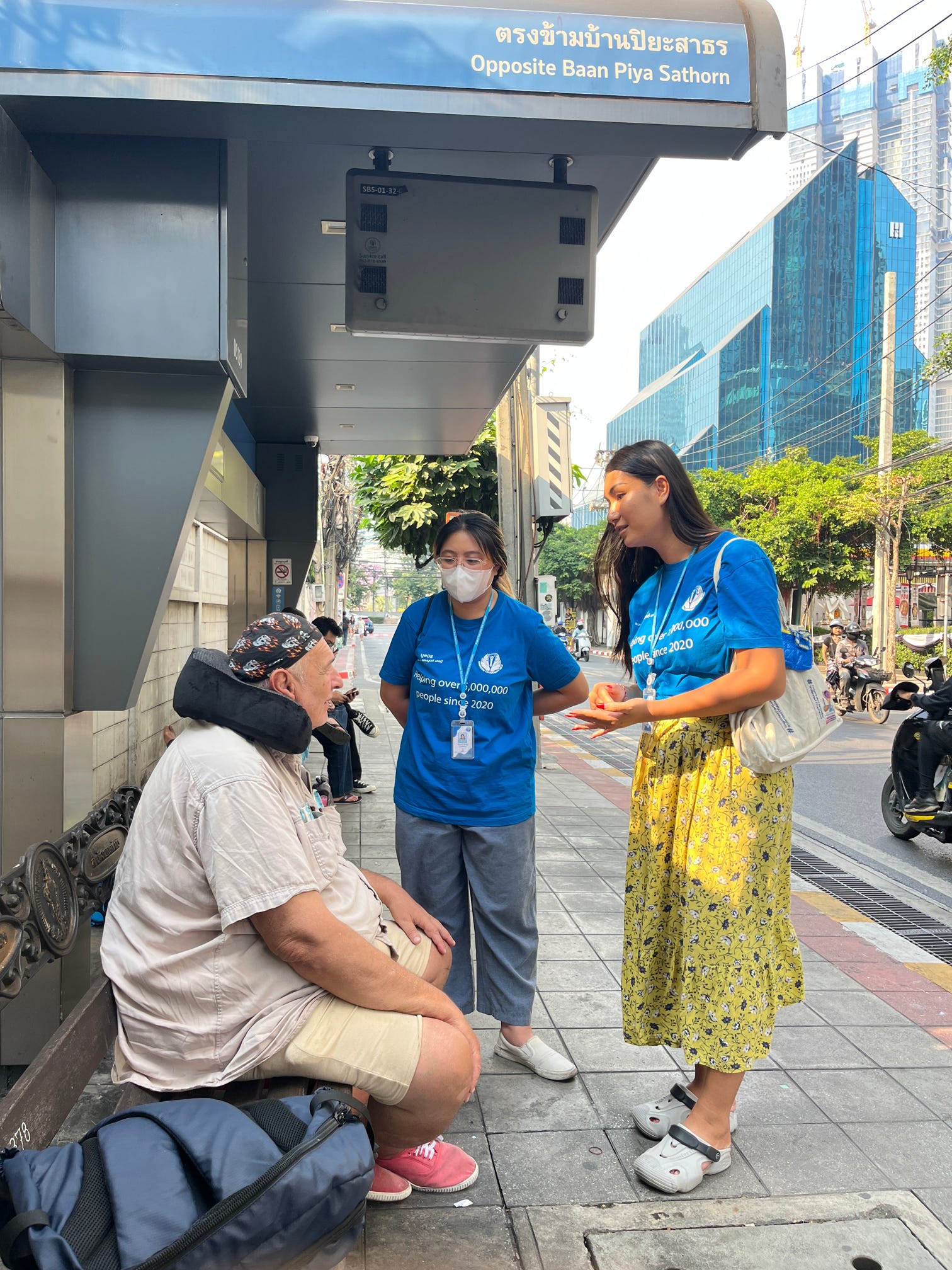 two young boys brushing their teeth in front of a crowd