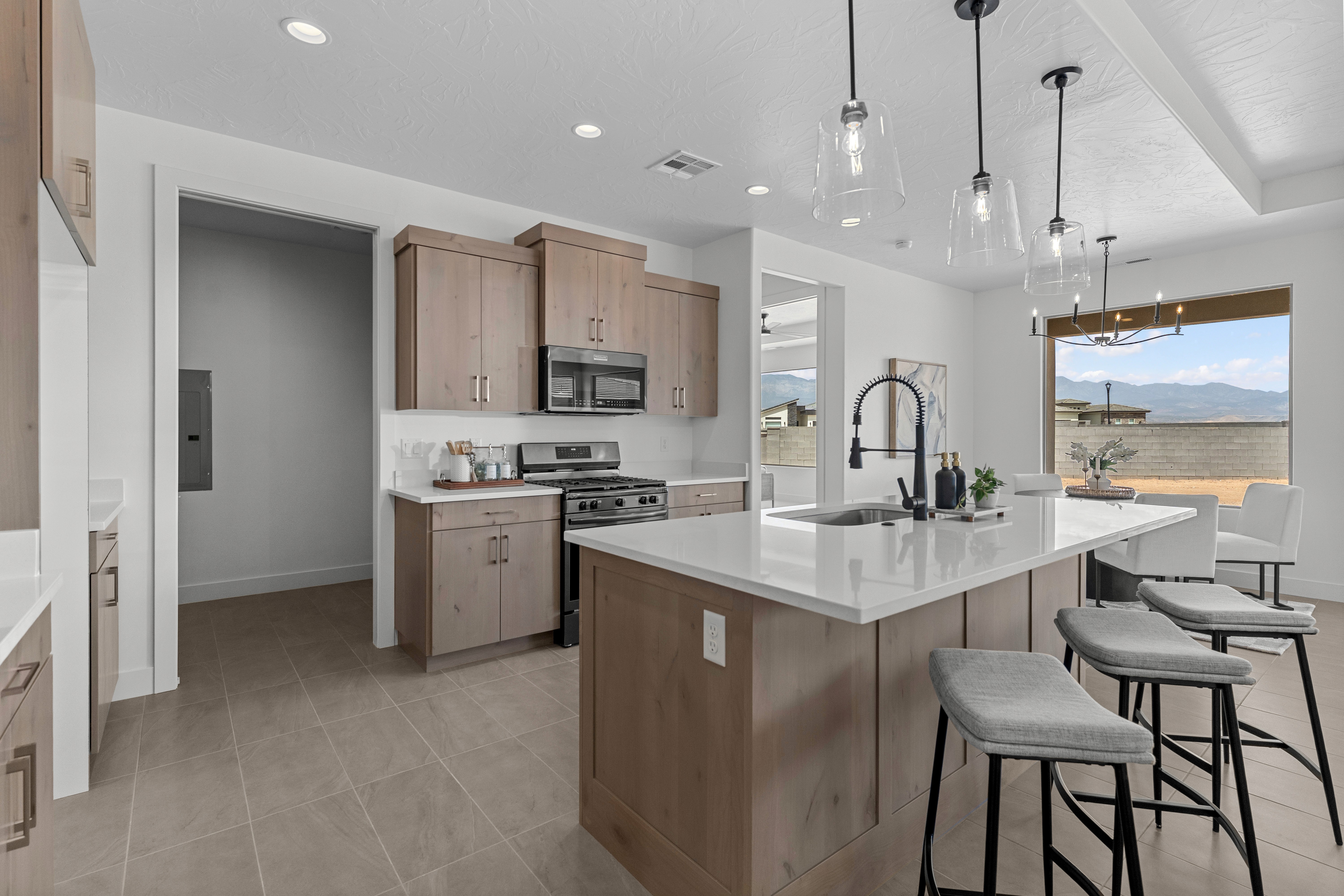 View from the kitchen into the dining area in The Nest at Falcon Ridge, showcasing open layout and light-filled space.