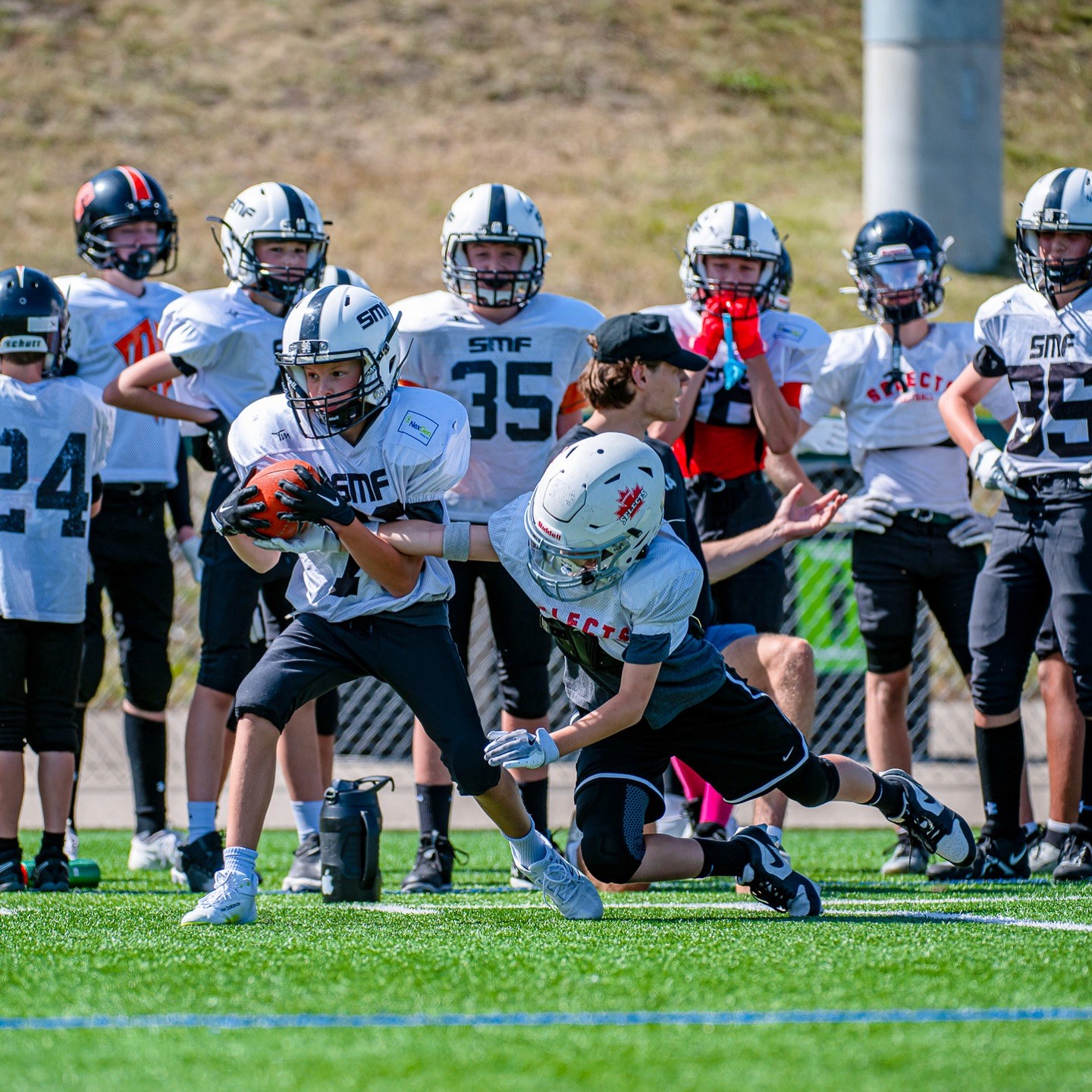 Saskatoon Minor Football players competing in a game at a multi-location sports program 