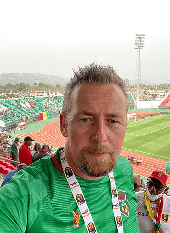 Group of men standing with Sufboard