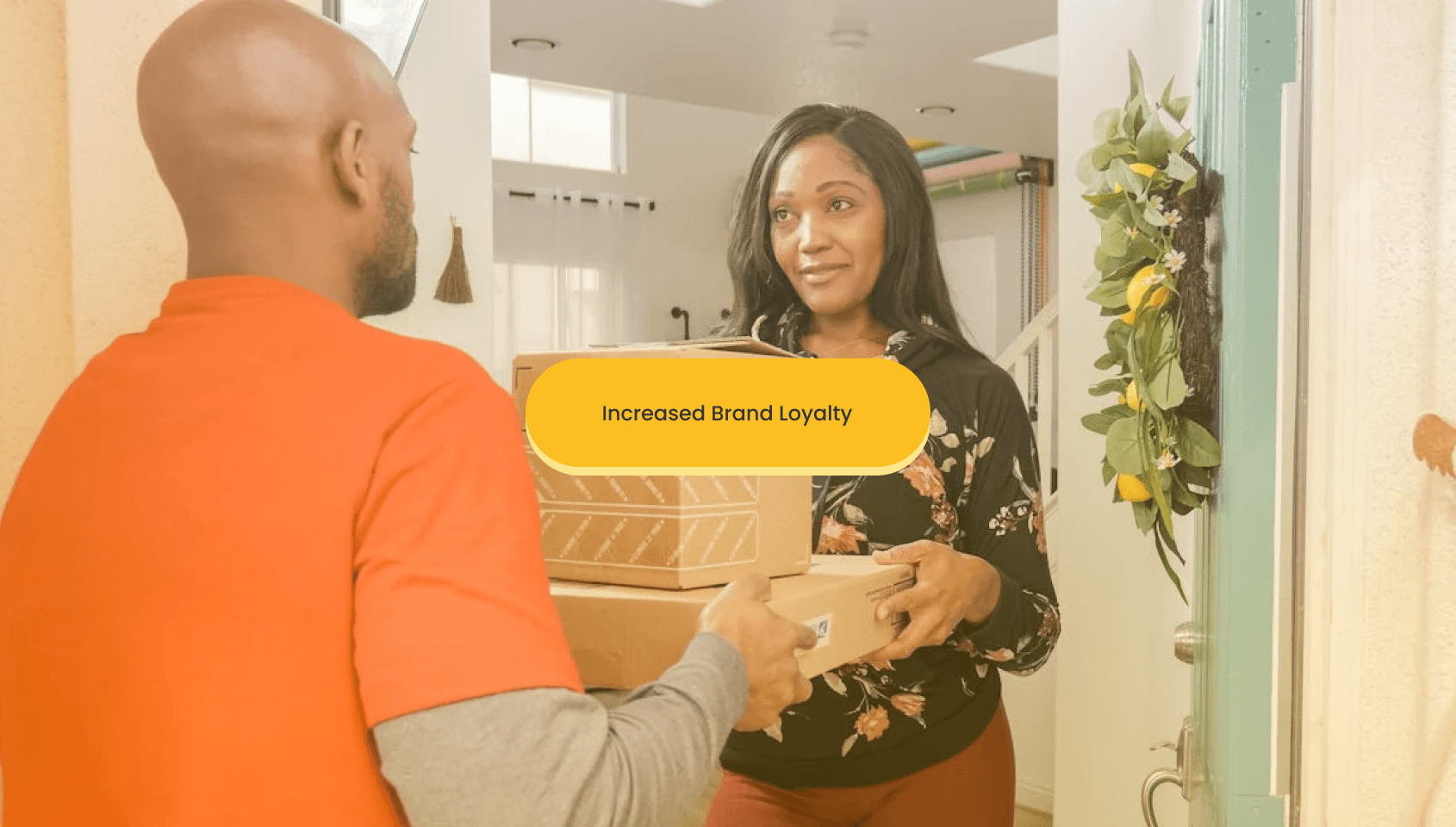 A courier person gives the parcel to a happy customer.