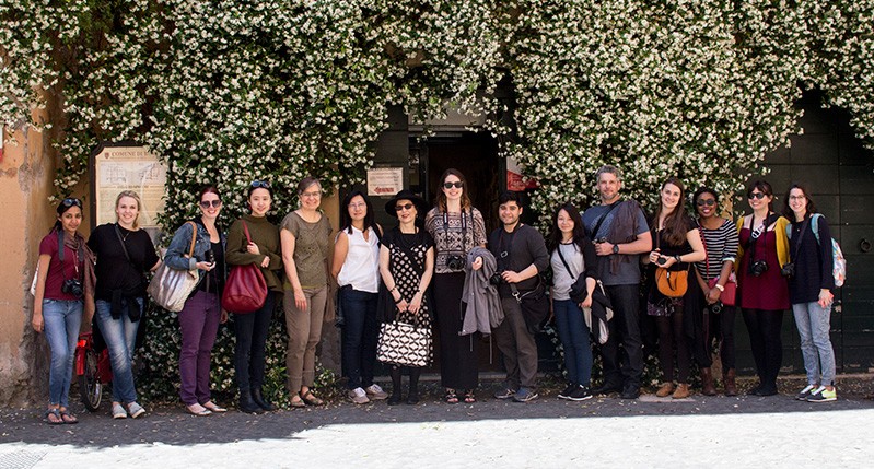 people group in front of door with flowers