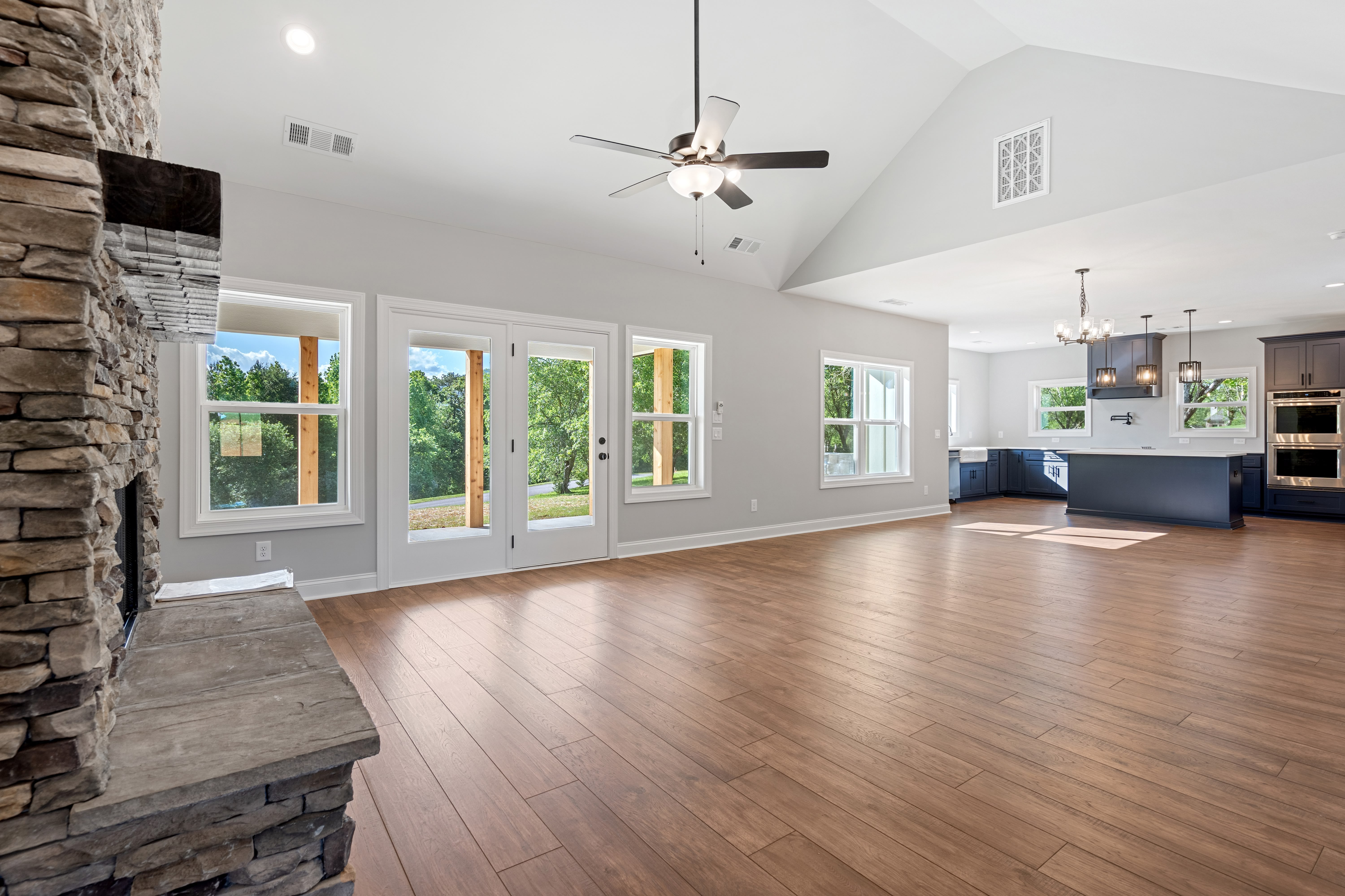Spacious guest bedroom with hardwood floors
