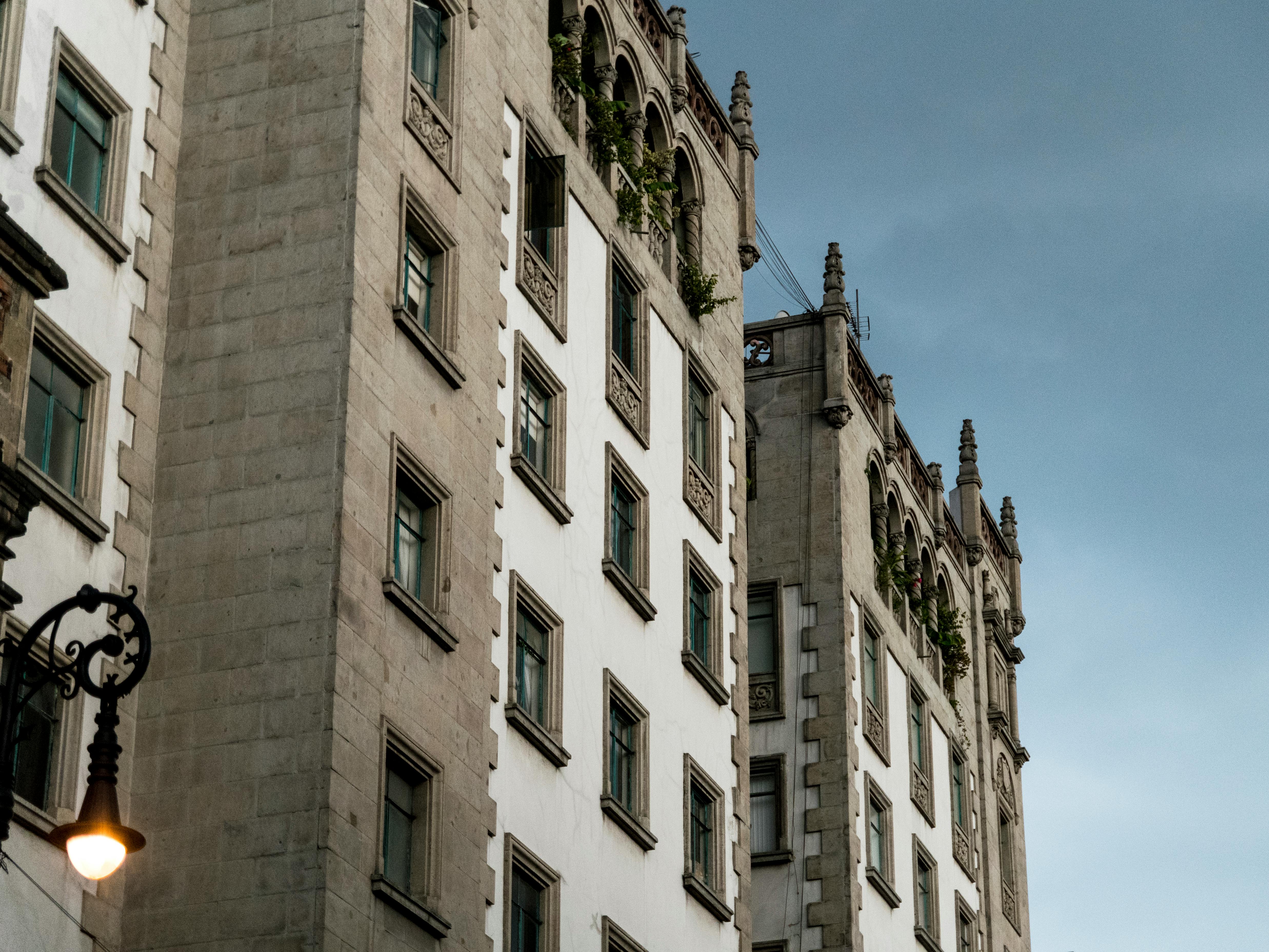a building with a walkway and trees