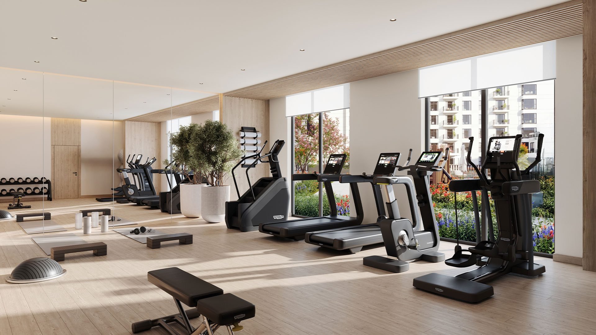 A gym room at Rosewell at Town Square featuring exercise equipment and large windows for natural light.