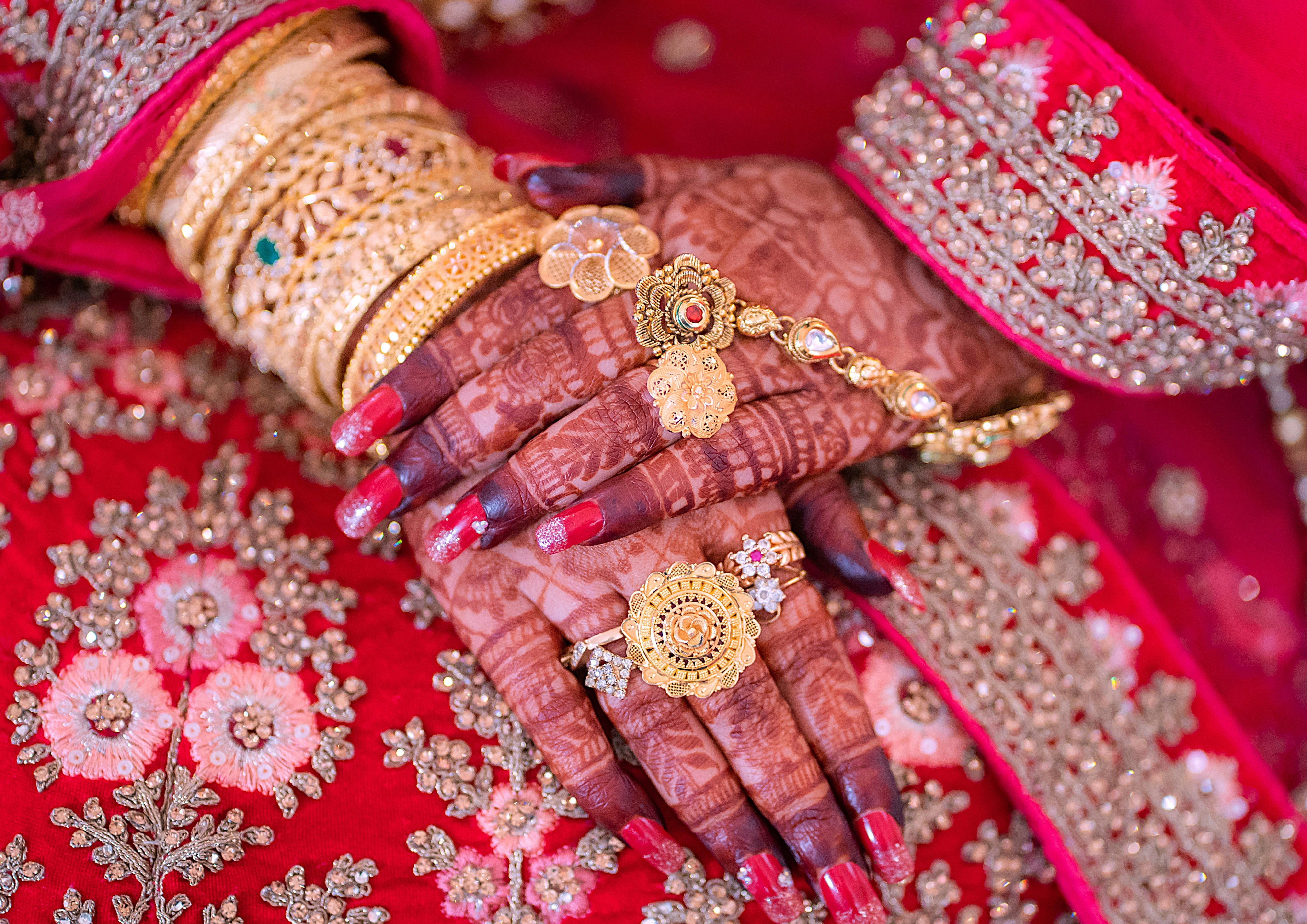 A close up of a woman's hands with jewelry on it
