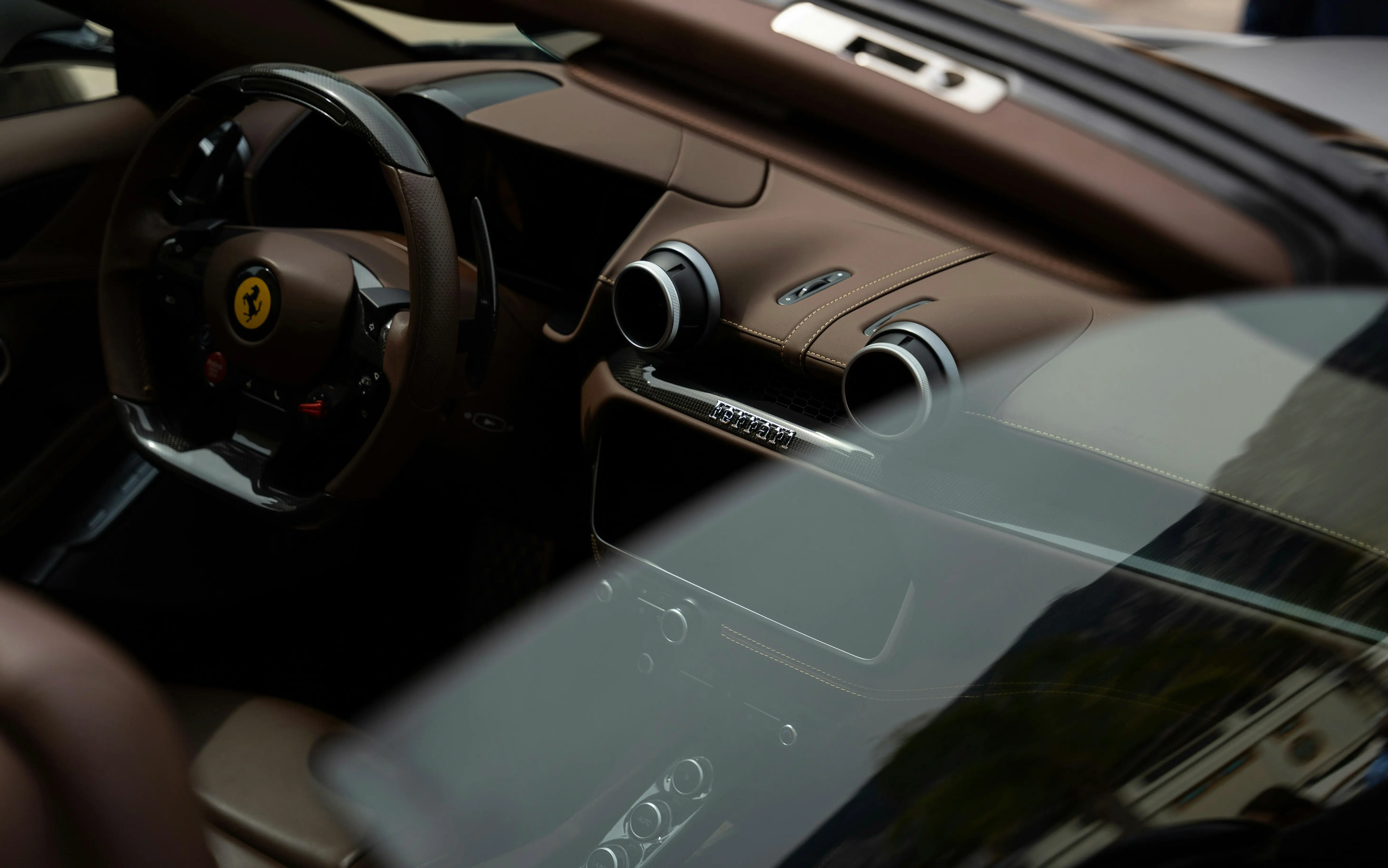 Luxury vehicle interior showcasing detailed craftsmanship and restored dashboard and seating surfaces.