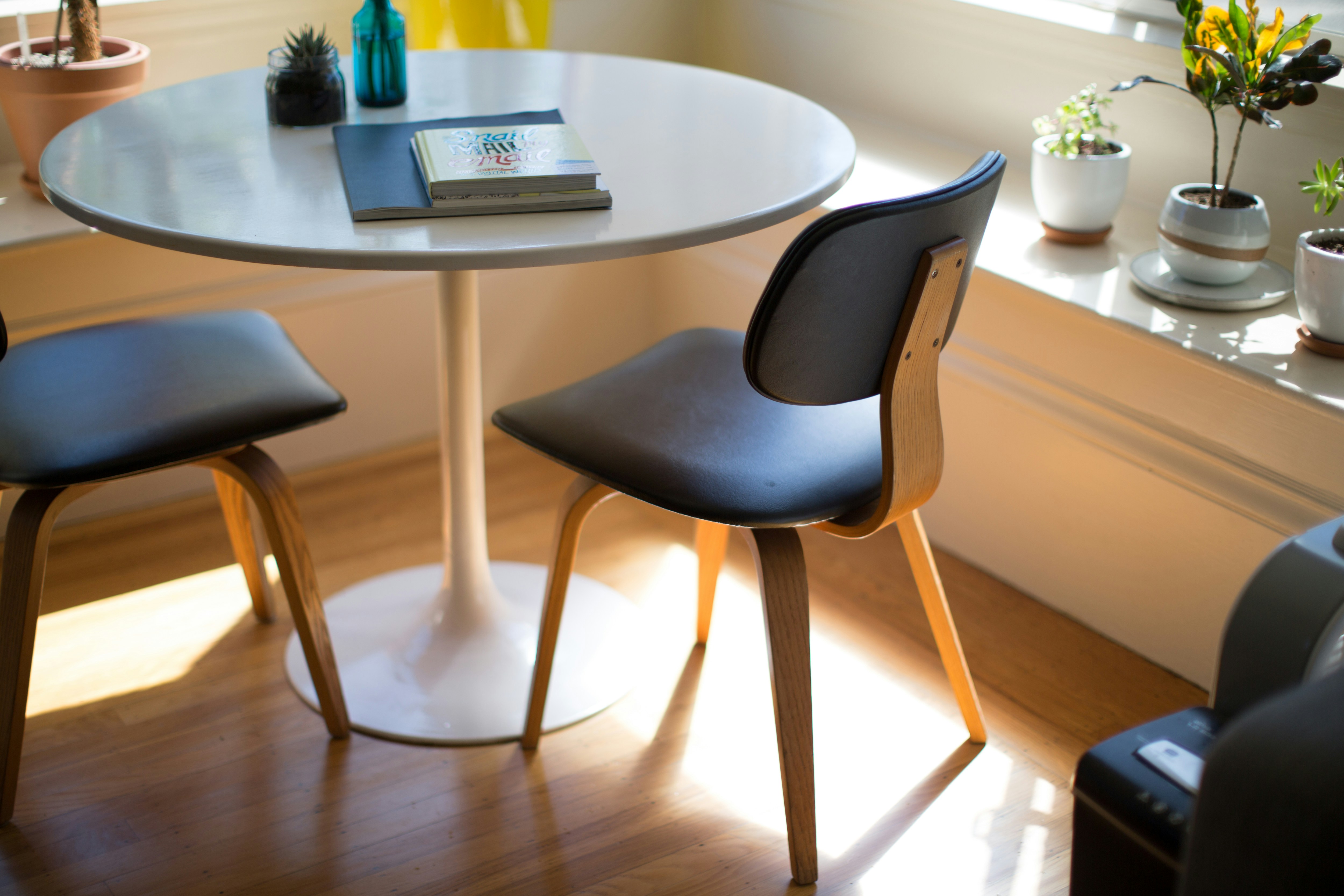 Dining area with a round table and modern chairs.