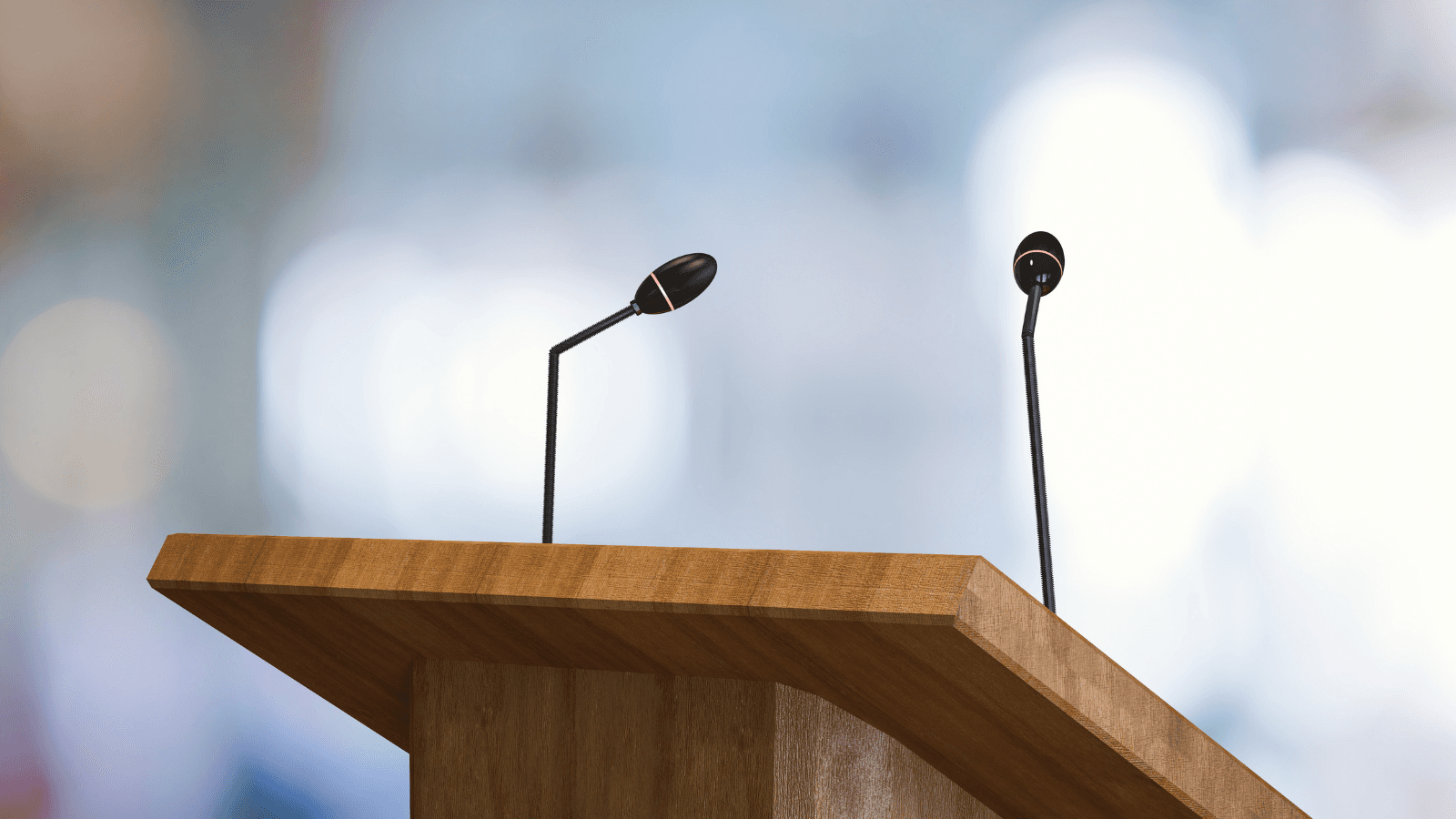 A podium with two microphones, hinting at an upcoming speech or presentation