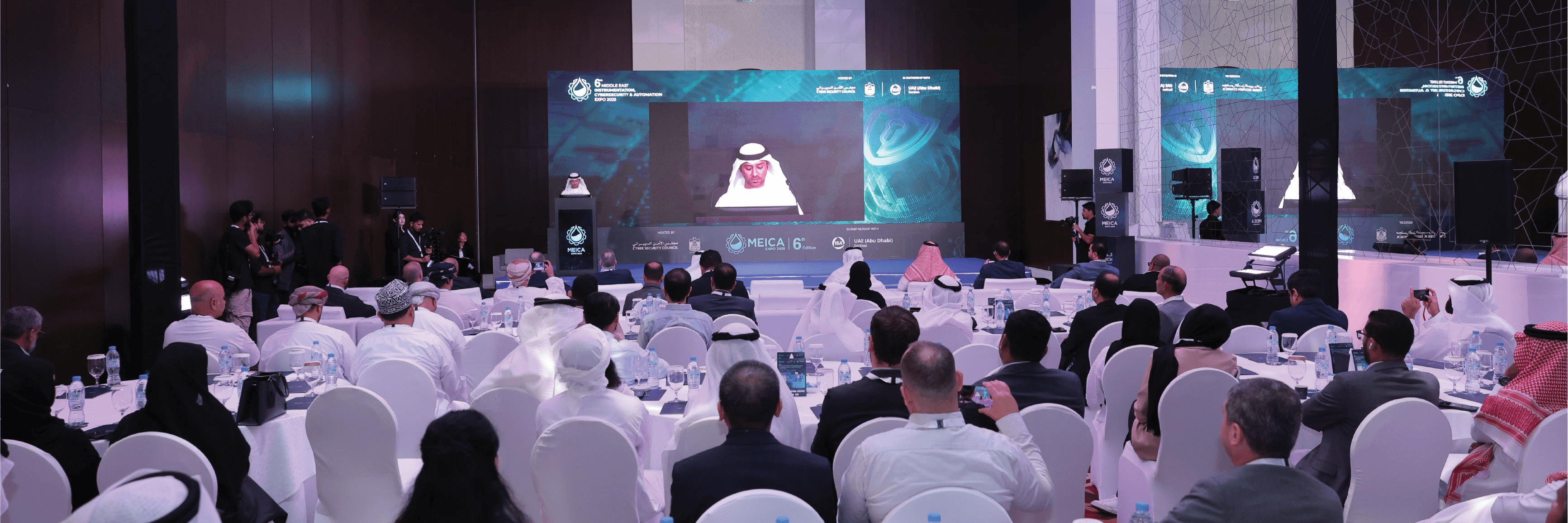 Man in VR headset interacts with green holographic code displayed on a curved screen.
