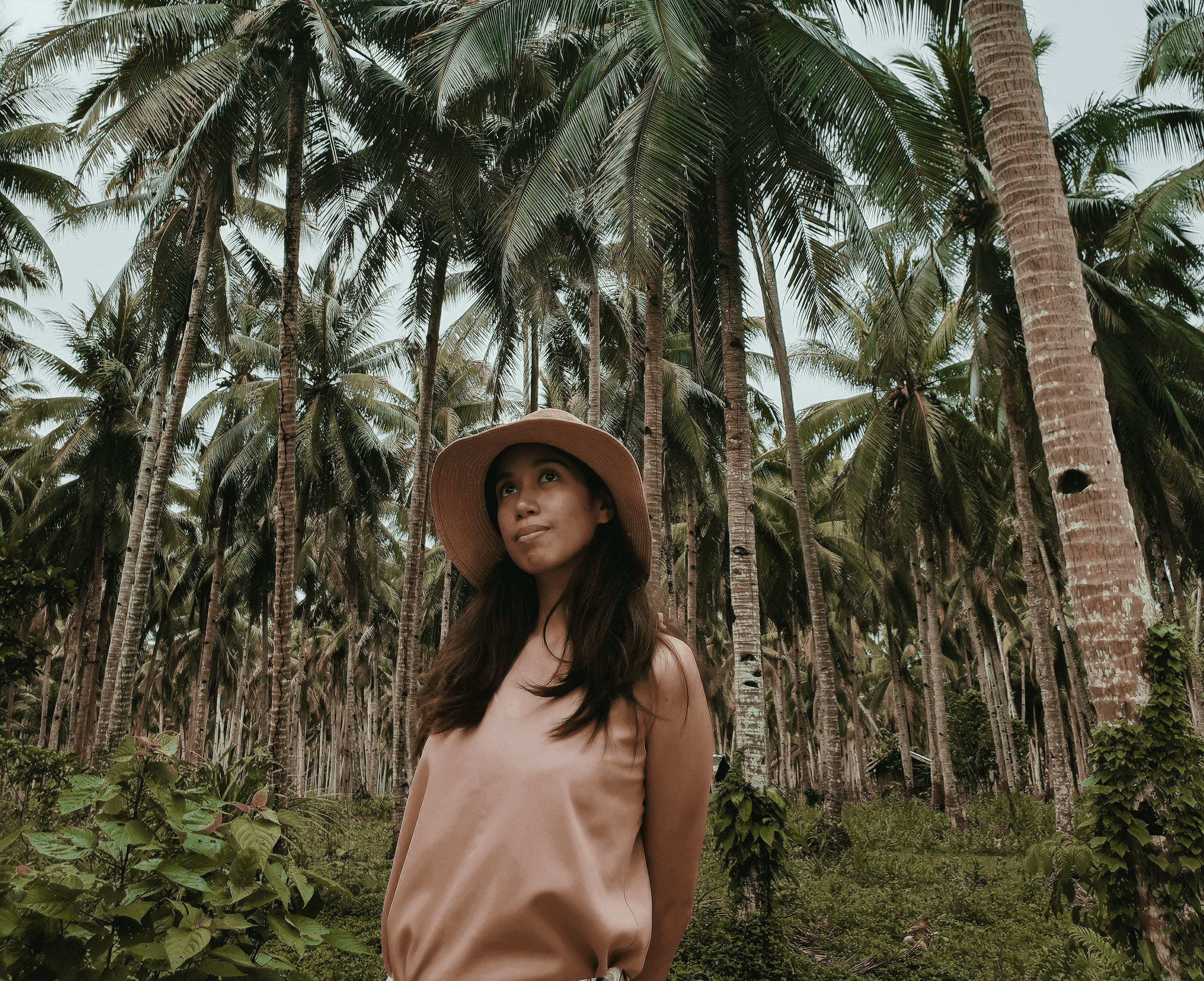 smiling woman wearing white and black pinstriped collared top