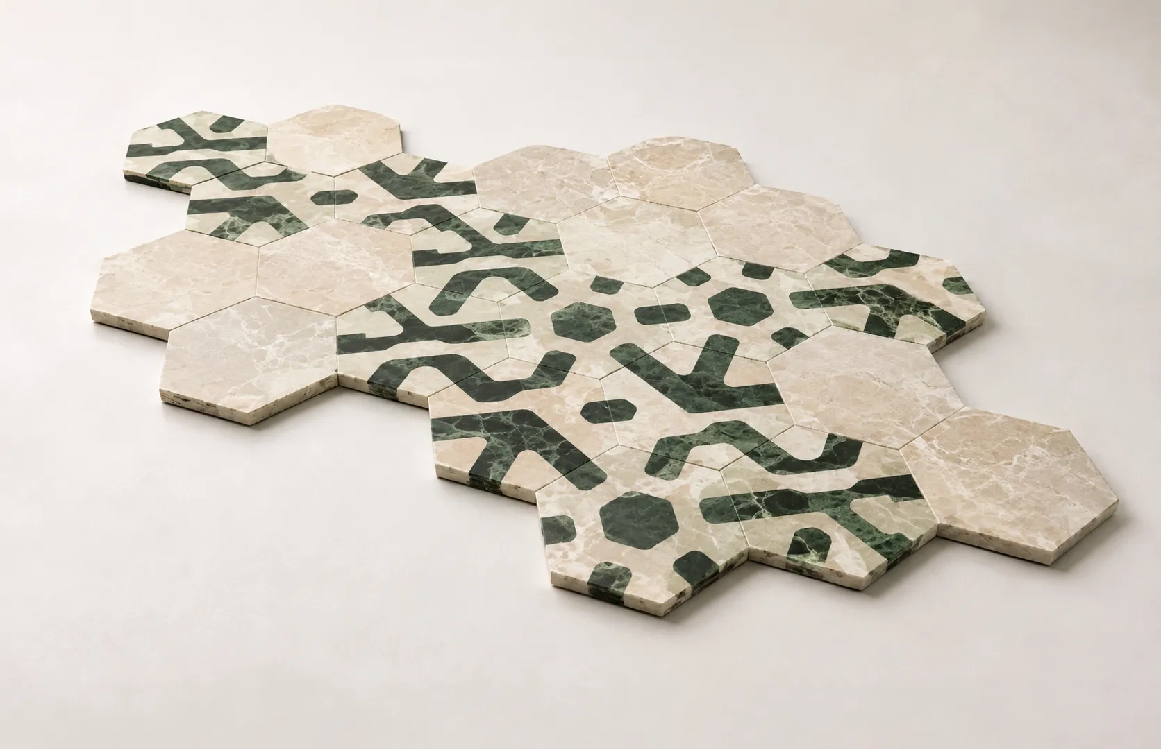 A composed arrangement of Tessera modular hexagonal marble tiles showing how the three units create a continuous surface pattern.