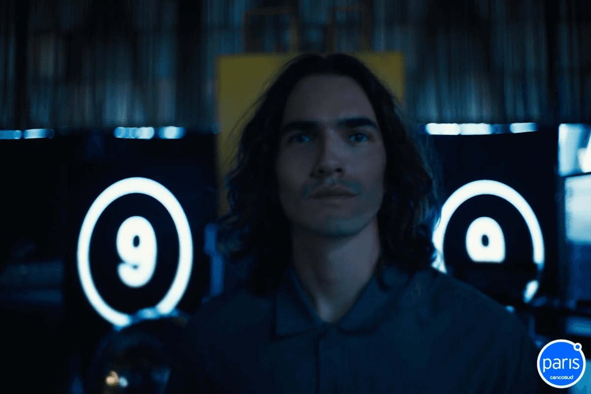 Blurred portrait of a woman with warm skin tones and a purple background.