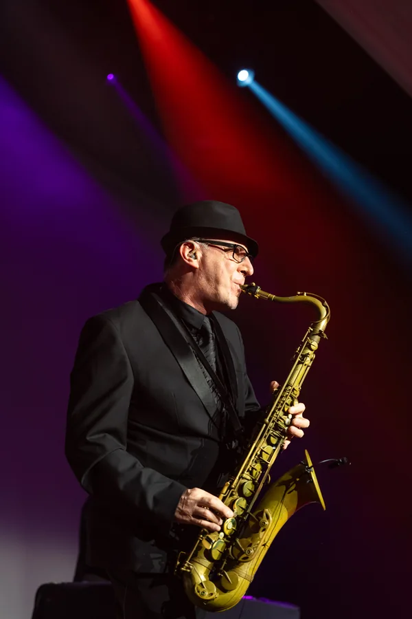 Saxophoniste sur scène sous des éclairages colorés lors d’un événement Malakoff Humanis au Pullman Montparnasse.