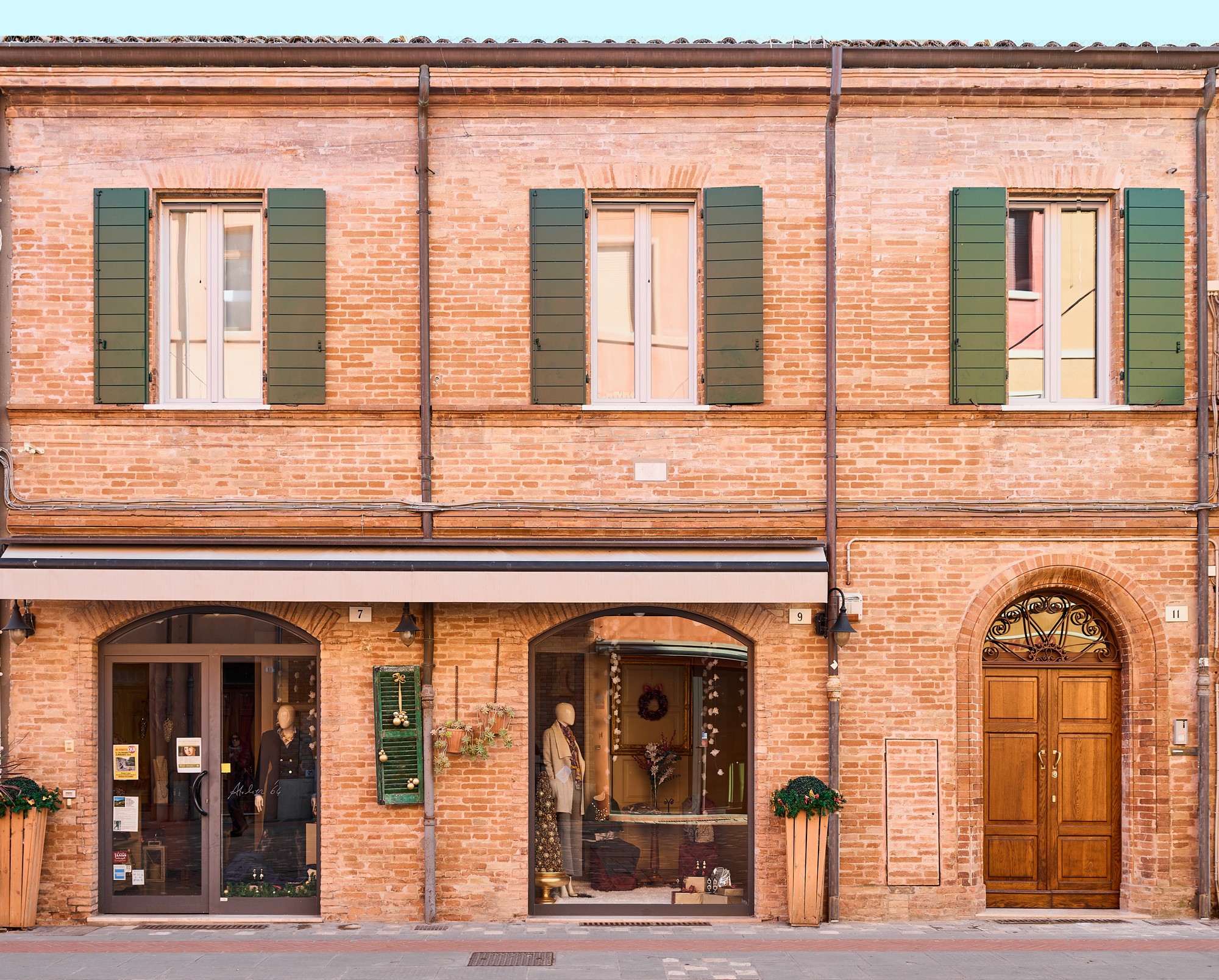 A woman lying on a massage bed, illuminated by soft sunlight streaming through a nearby window. A lush green plant in the background enhances the peaceful and rejuvenating ambiance.
