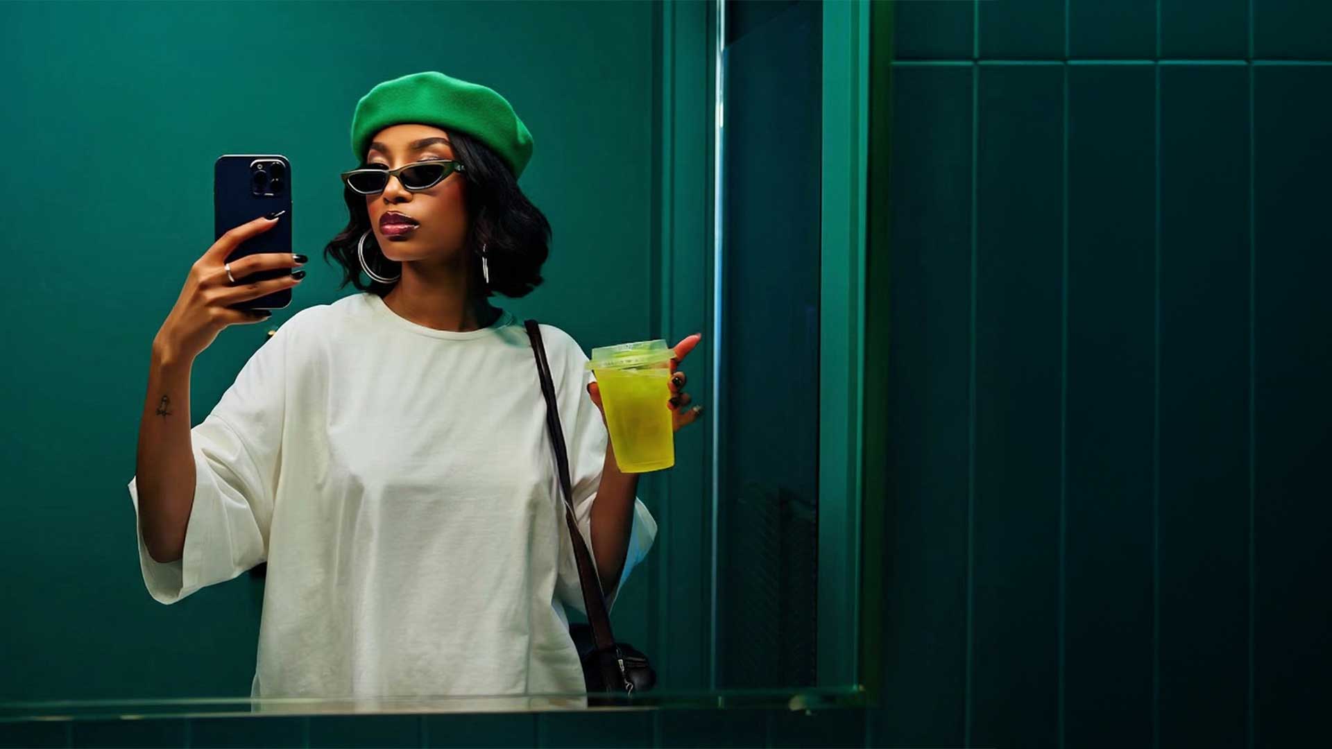 Content creator taking a selfie with smartphone, representing an AI powered creative content team