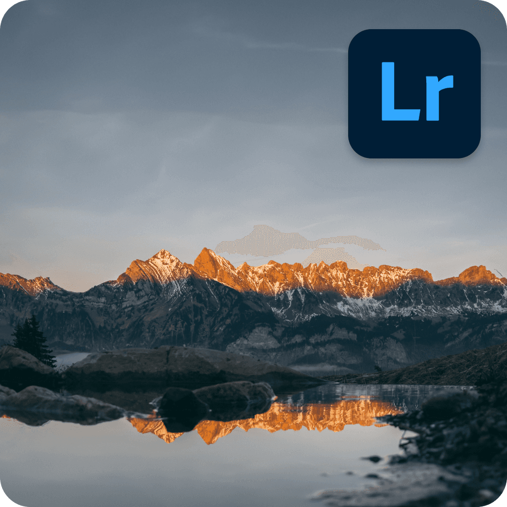 A still body of water with mountains in the background at sunset