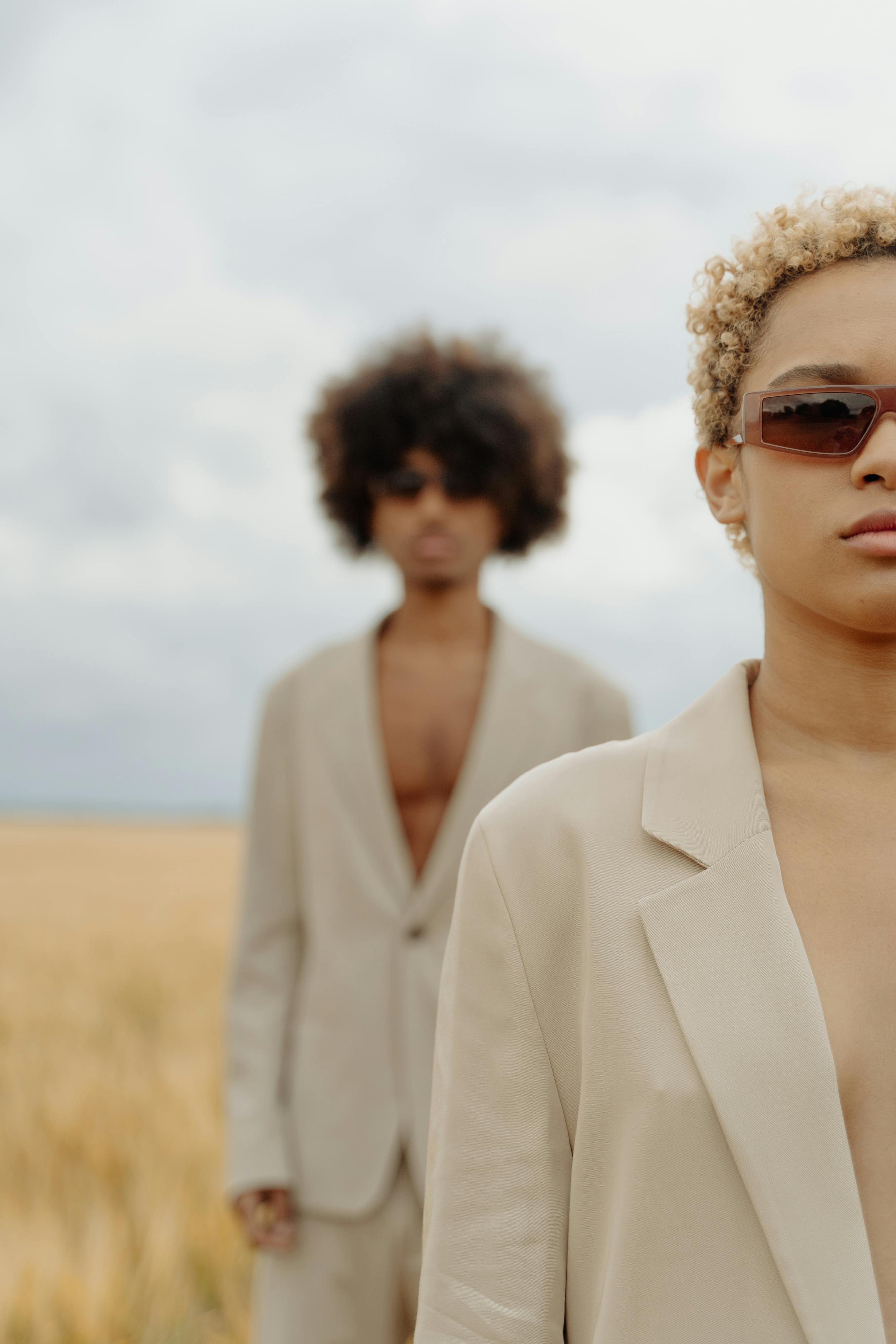 Man standing behind a woman in a blurred focus