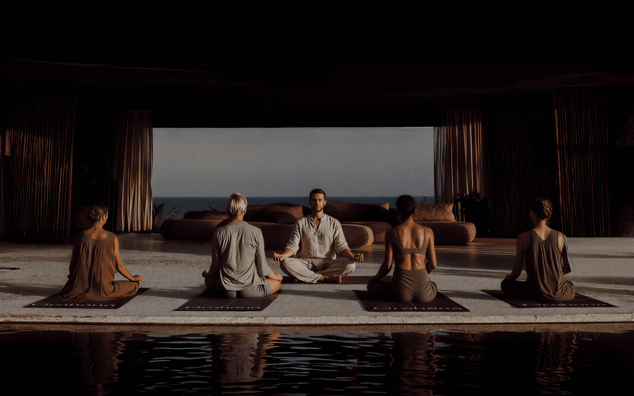 Grāhanå branding case study by Astrophat Studio — a wellness retreat yoga scene overlooking the sea, illustrating conscious luxury, minimalist architecture, and holistic design in the hospitality industry.