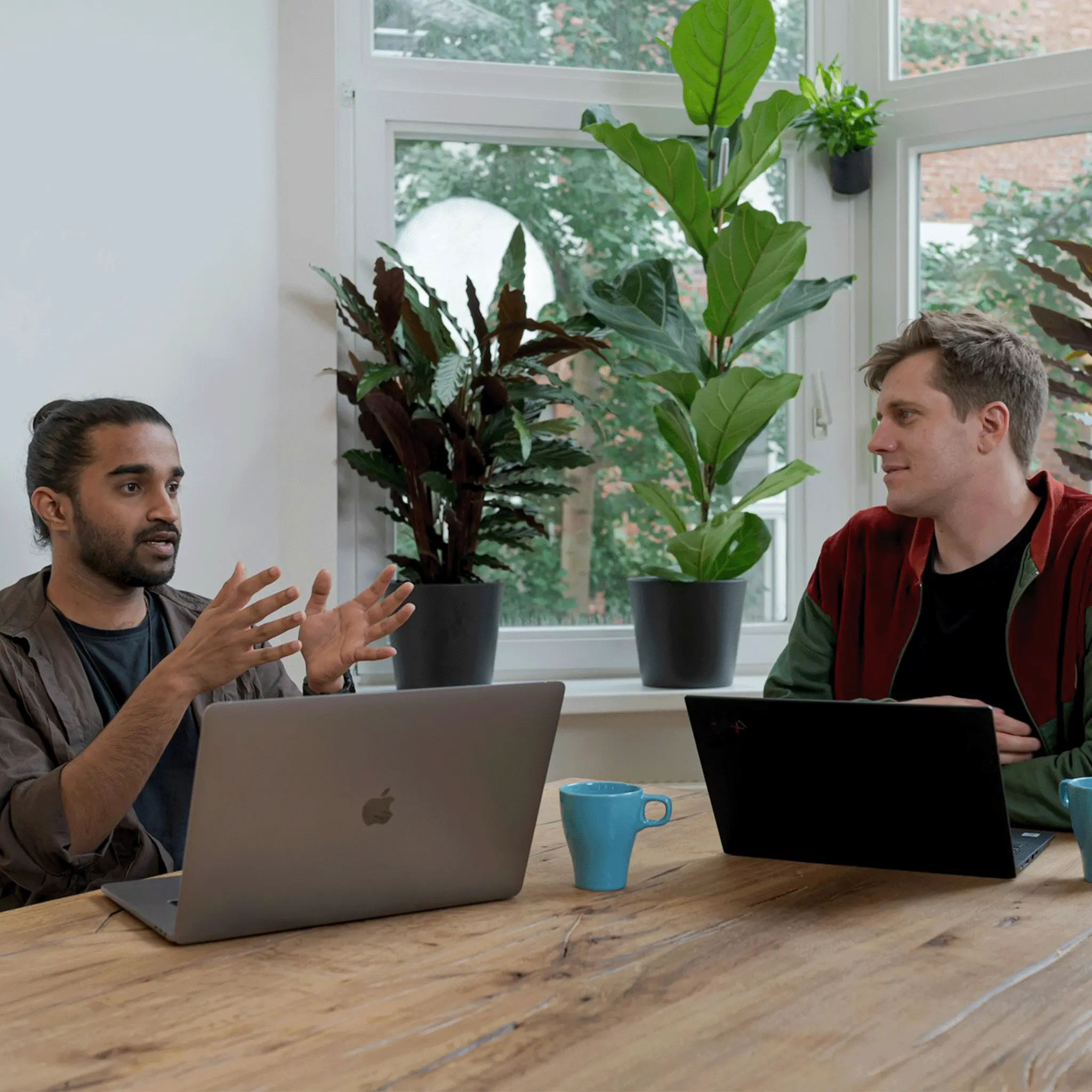 two men discussing embracing change in business at a table. 