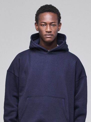 Man wearing Sunday Superior navy pullover hoodie