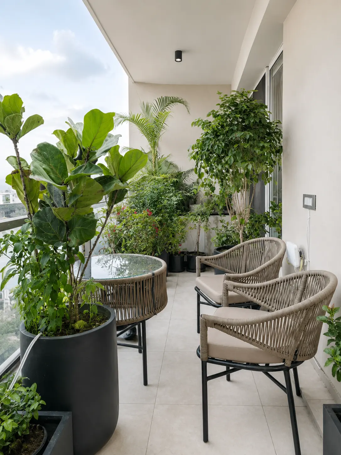 Balcony garden with seating, planters, tropical theme