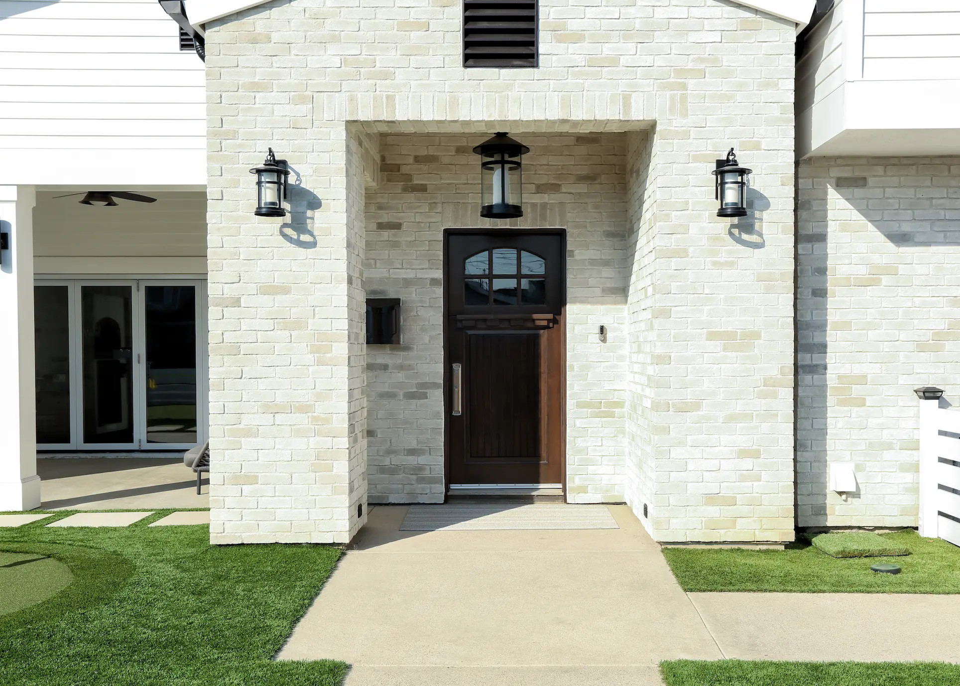 Front view of American Farmhouse home entryway with white brick facing. Photo by Chris Darnall.