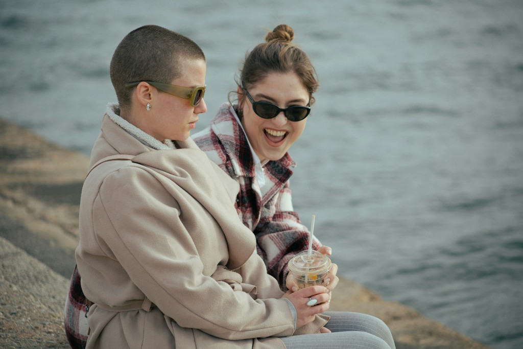 a couple of women sitting next to each other