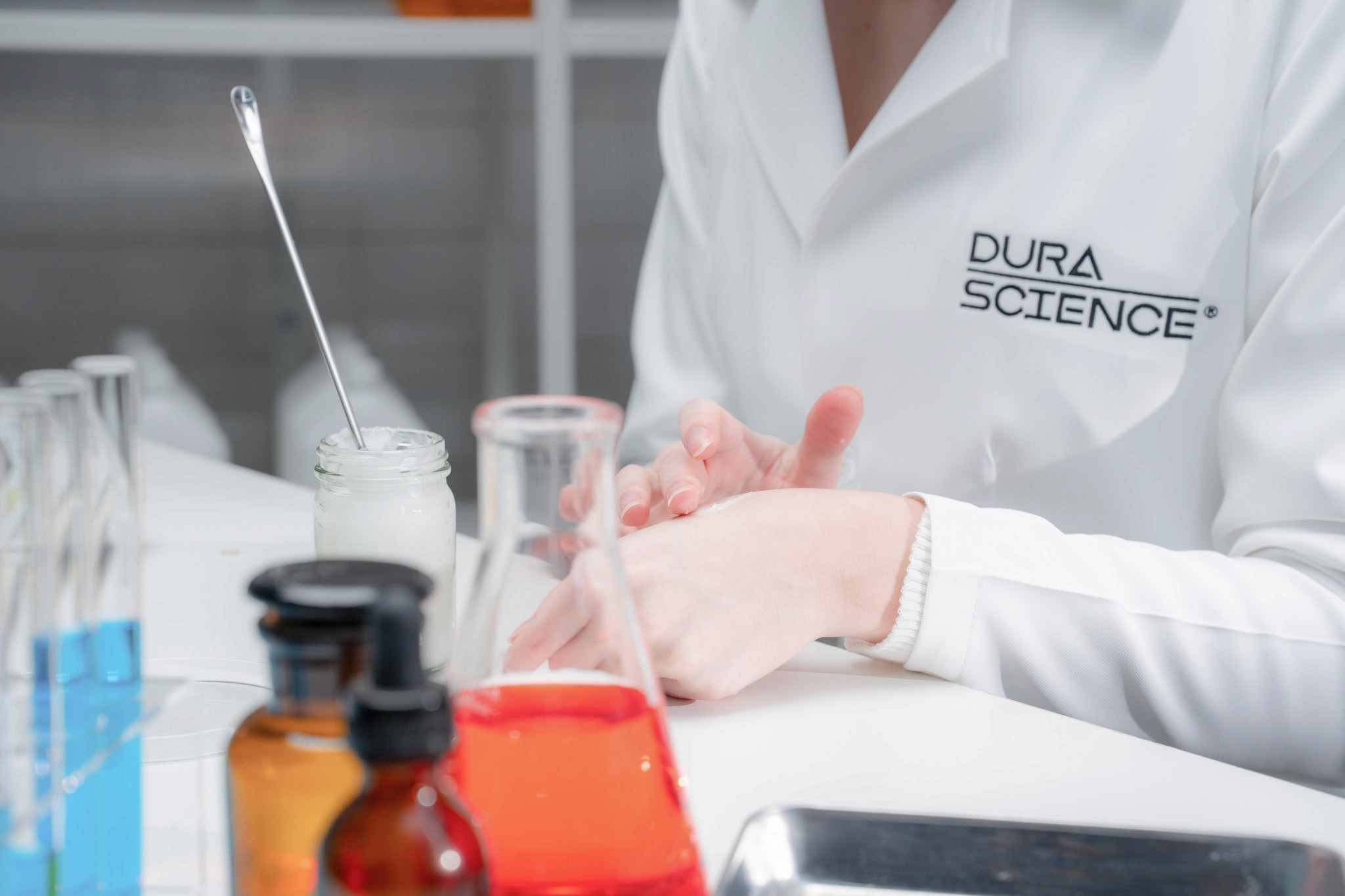 Scientist uses pipette to extract liquid in a lab.