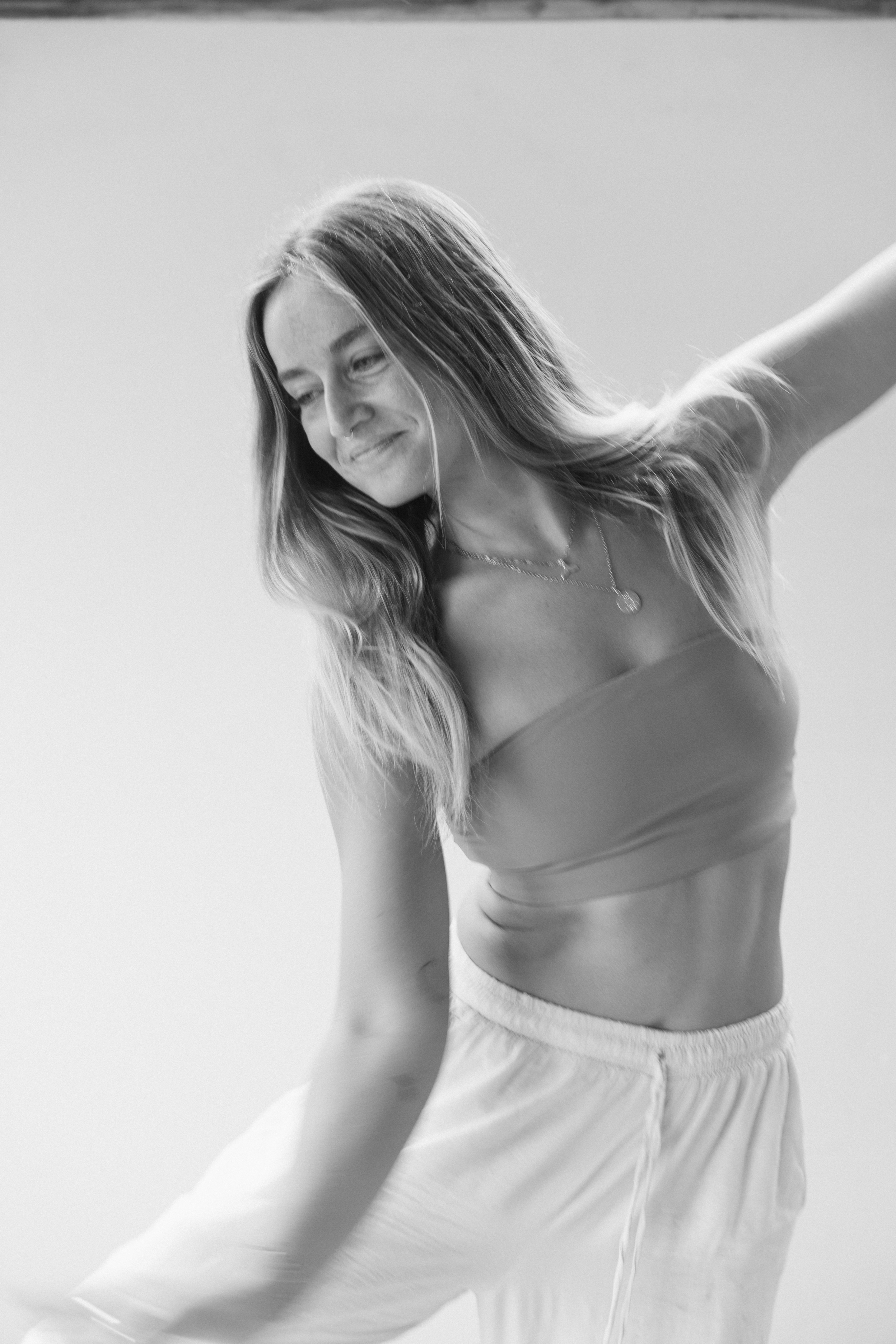 A girl holding her head in both hands looking to the side