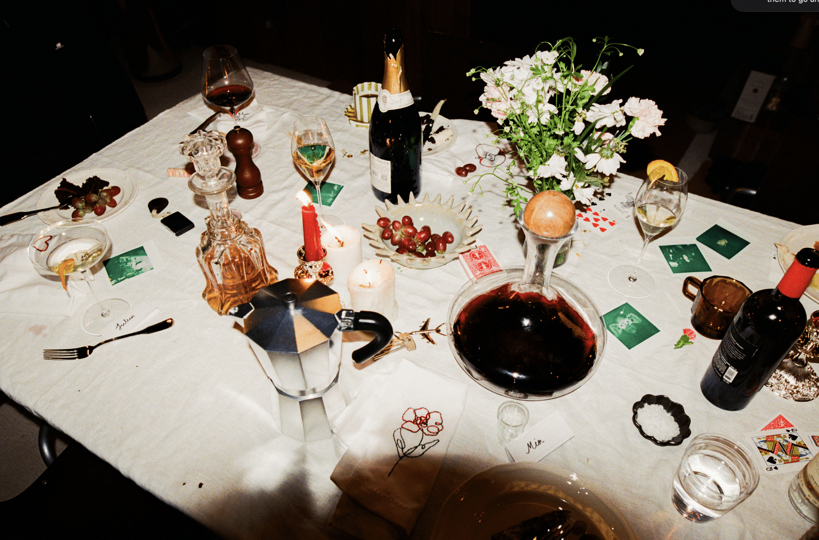 A decorative floral arrangement spills over a table draped in red fabric, creating an elegant atmosphere.