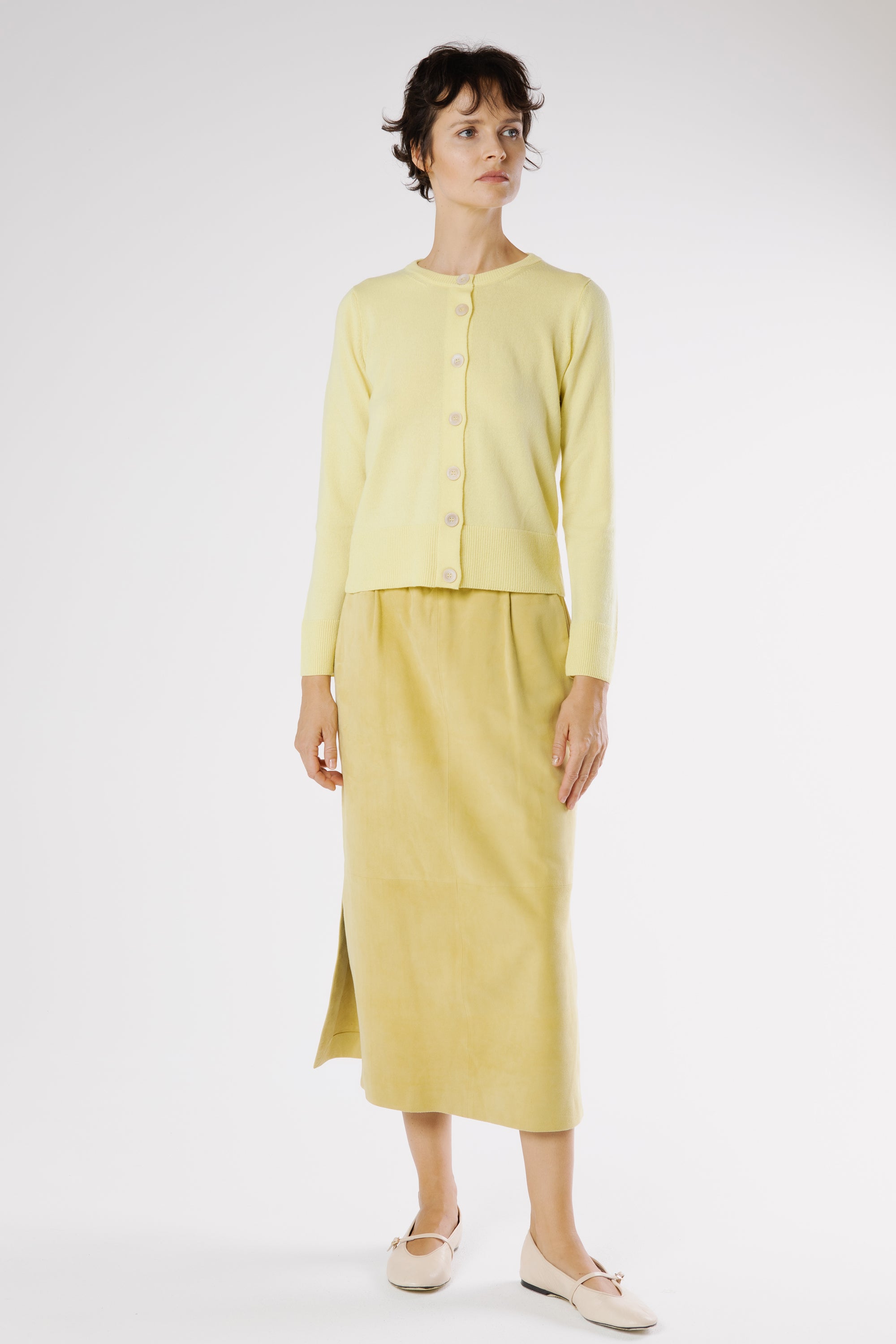 Lemu suede midi skirt styled with matching knit cardigan and flats