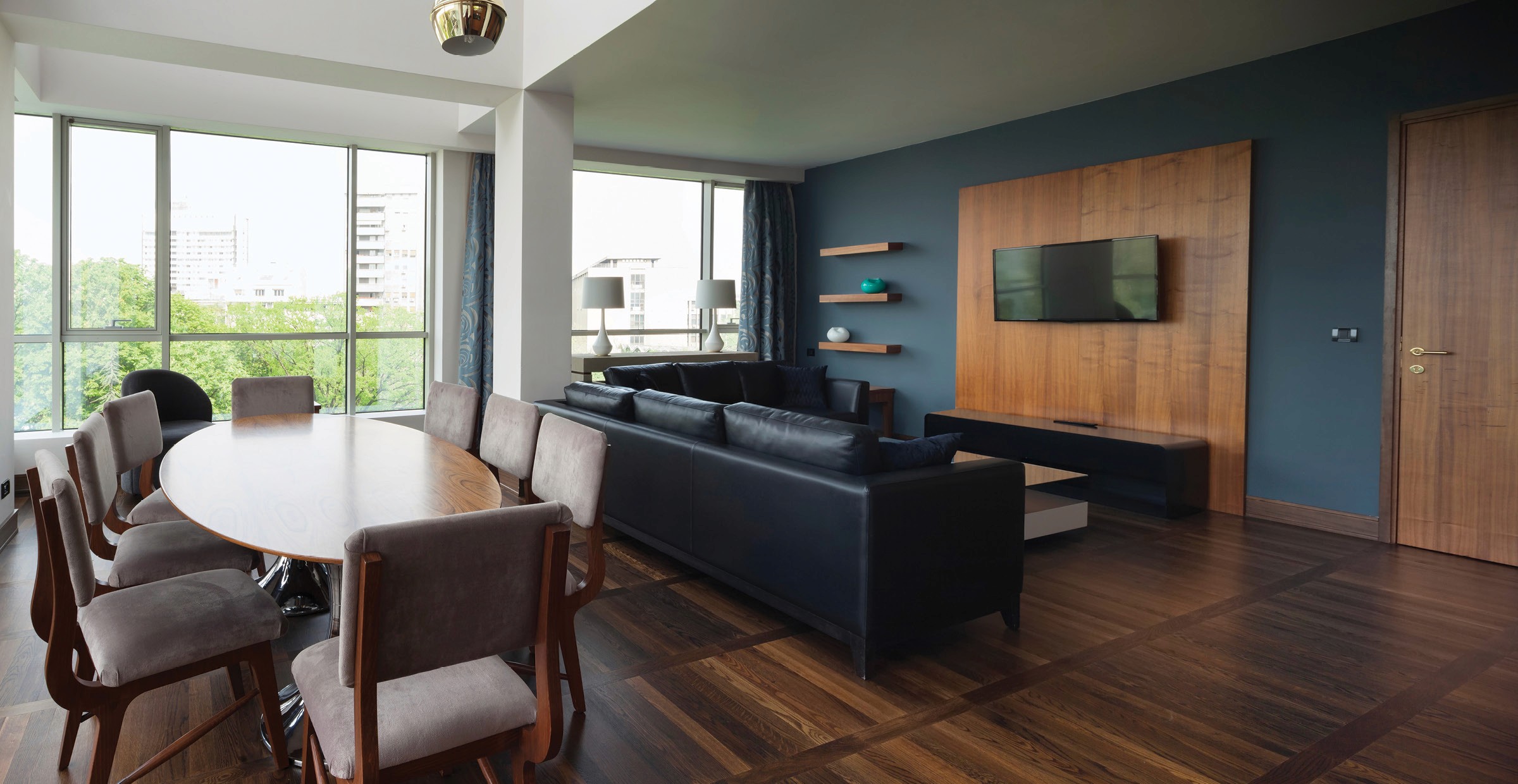 Dining table and living area with sofas and TV