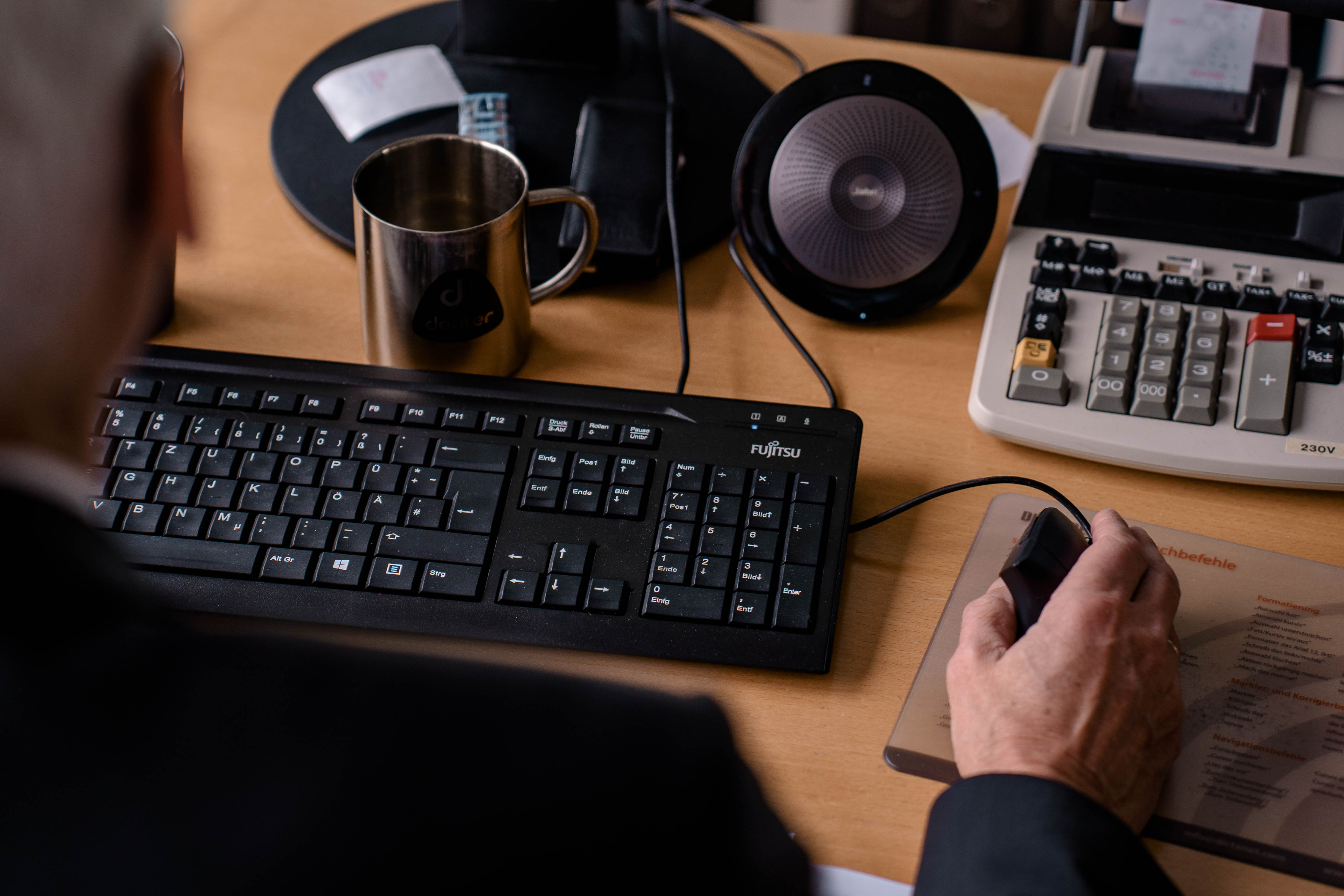 Someone sitting on a keyboard at the computer