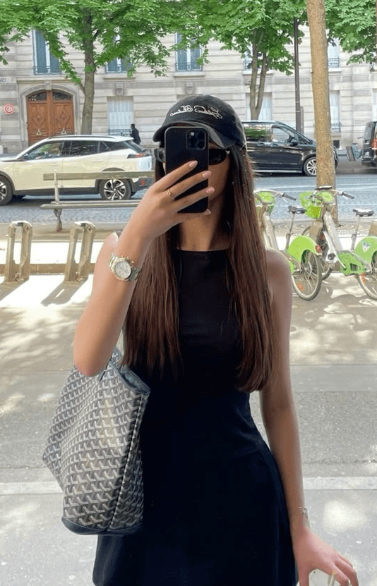 woman in black long sleeve shirt sitting on white couch