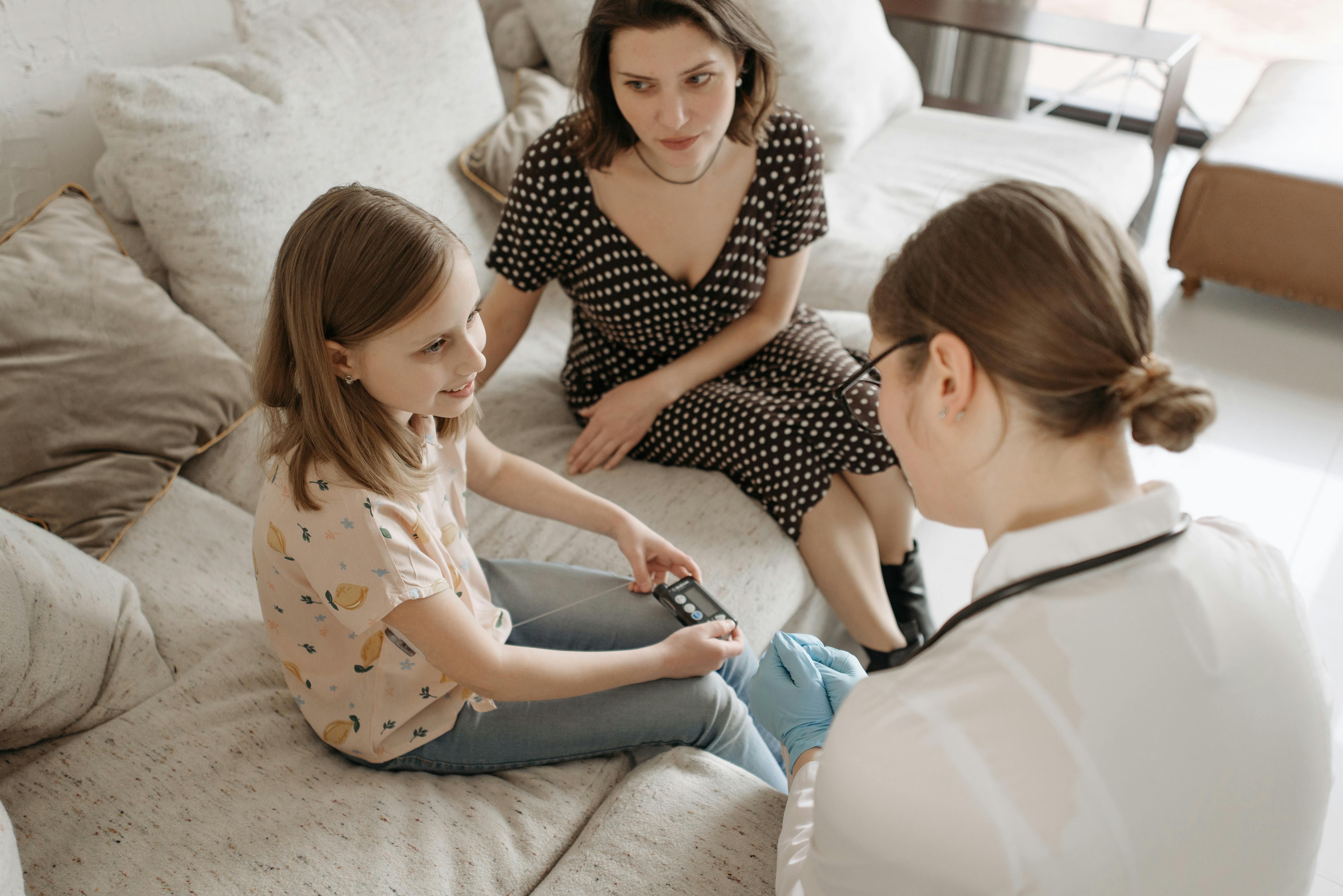 Conversion Truth for Families: Mother in polka dot dress sitting on couch with tween daughter and doctor