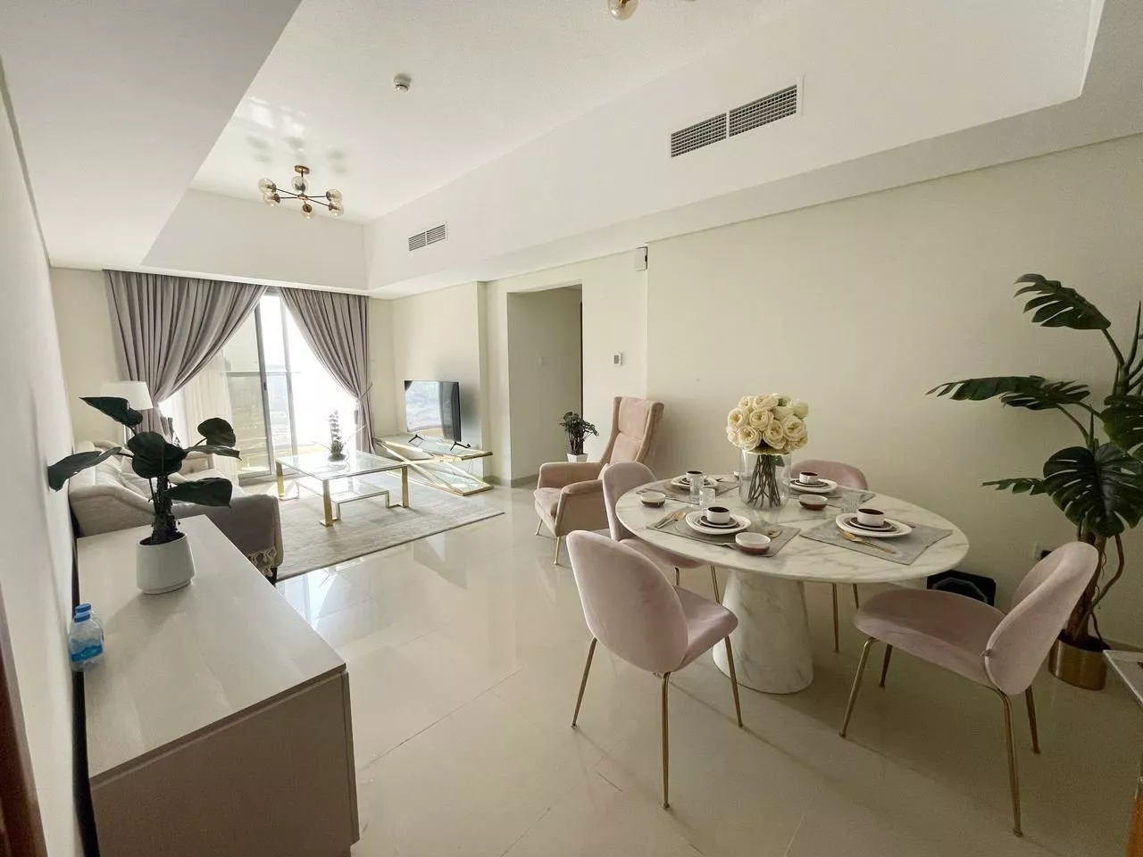 Spacious open-plan living and dining area in an Al Nuaimia 1 apartment with natural light.
